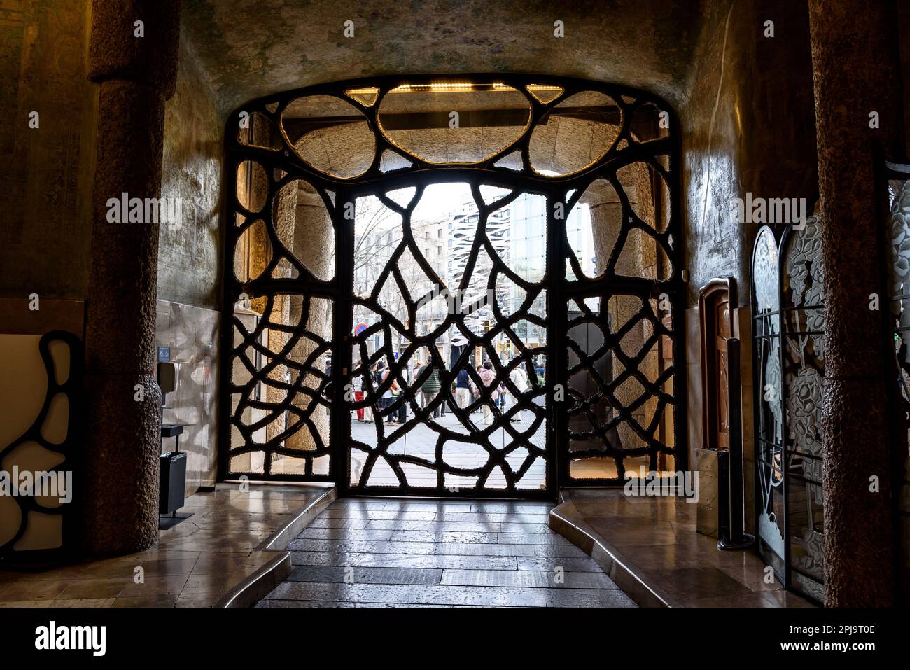 Wrought iron gate at the entrance of Casa Milà (La Pedrera) designed by Antoni Gaudí (Barcelona, Catalonia, Spain) ESP: Puerta de hierro forjado Stock Photo