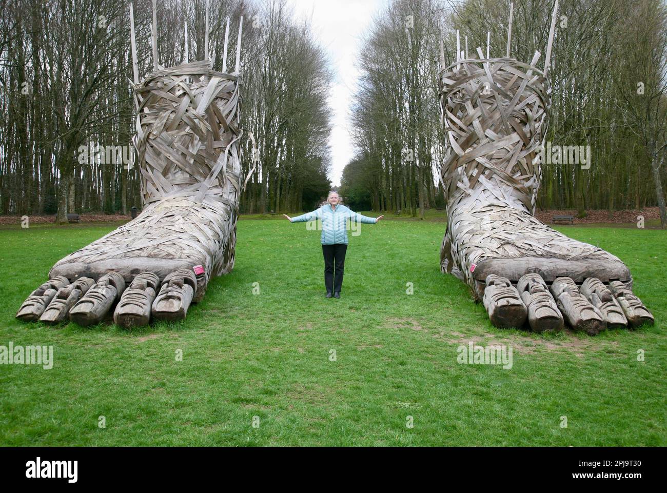 A lady positioned between two large feet at the Chateau de Flers, Normandy, France, Europe Stock Photo