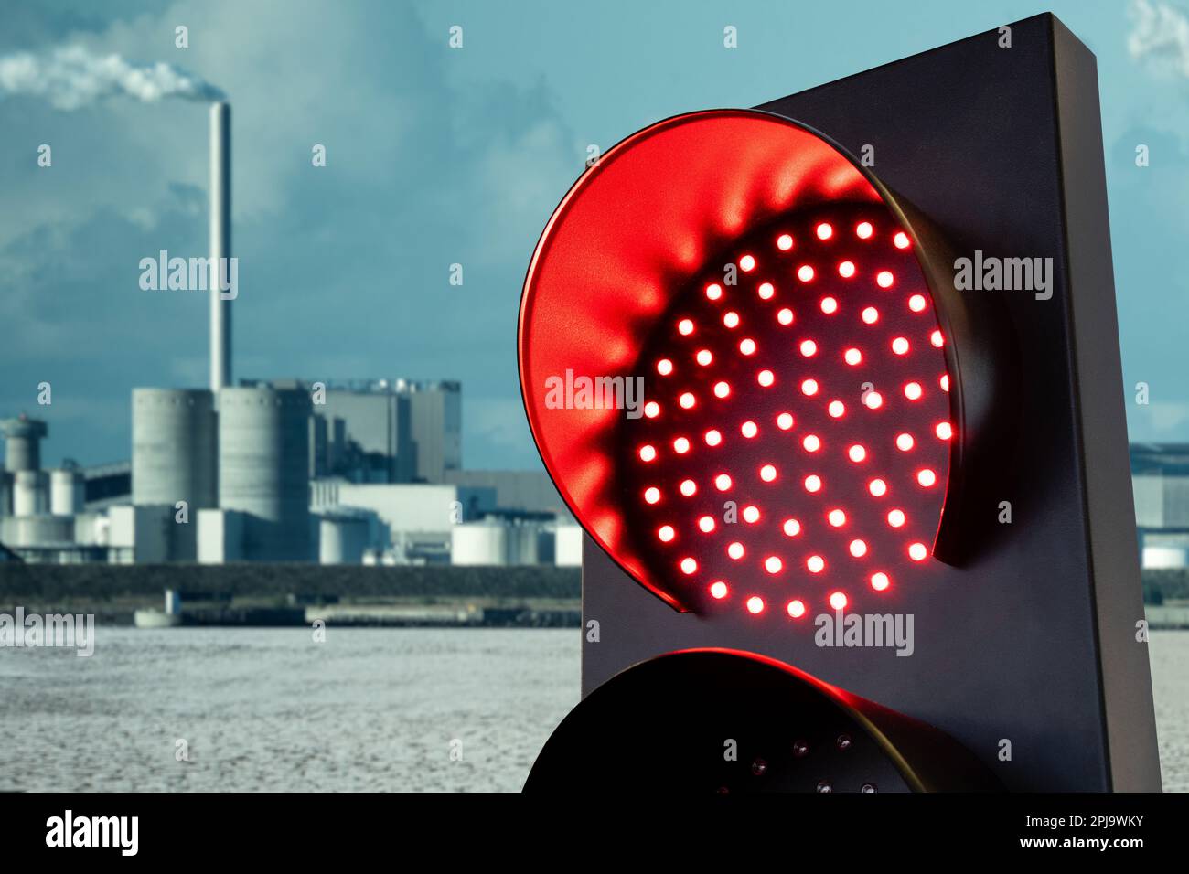 Red traffic light on a background of city after the effects of global warming and air pollution. High quality photo Stock Photo
