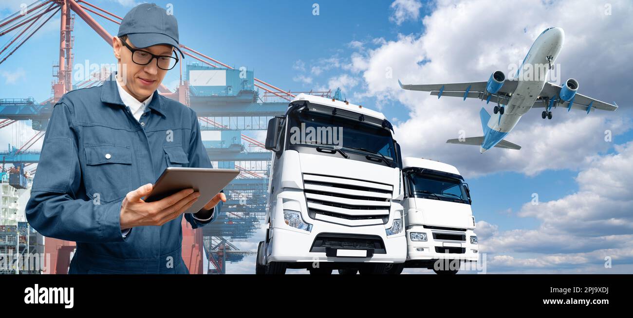 Manager with a digital tablet on a background of a ship in the seaport, airplane and trucks. International trade and logistics concept. Stock Photo