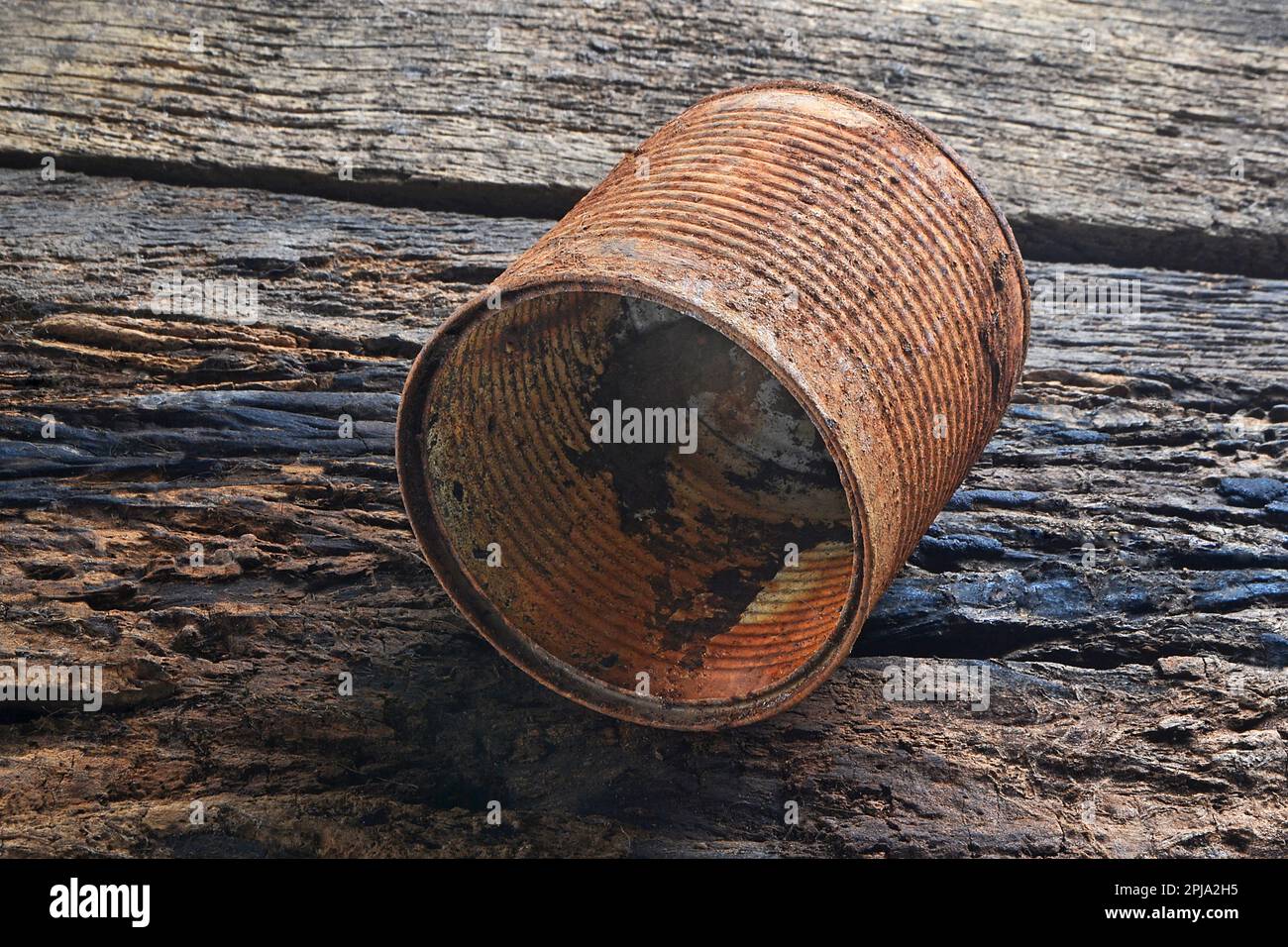 Close-up of old metal movie film reel canister on a wooden table