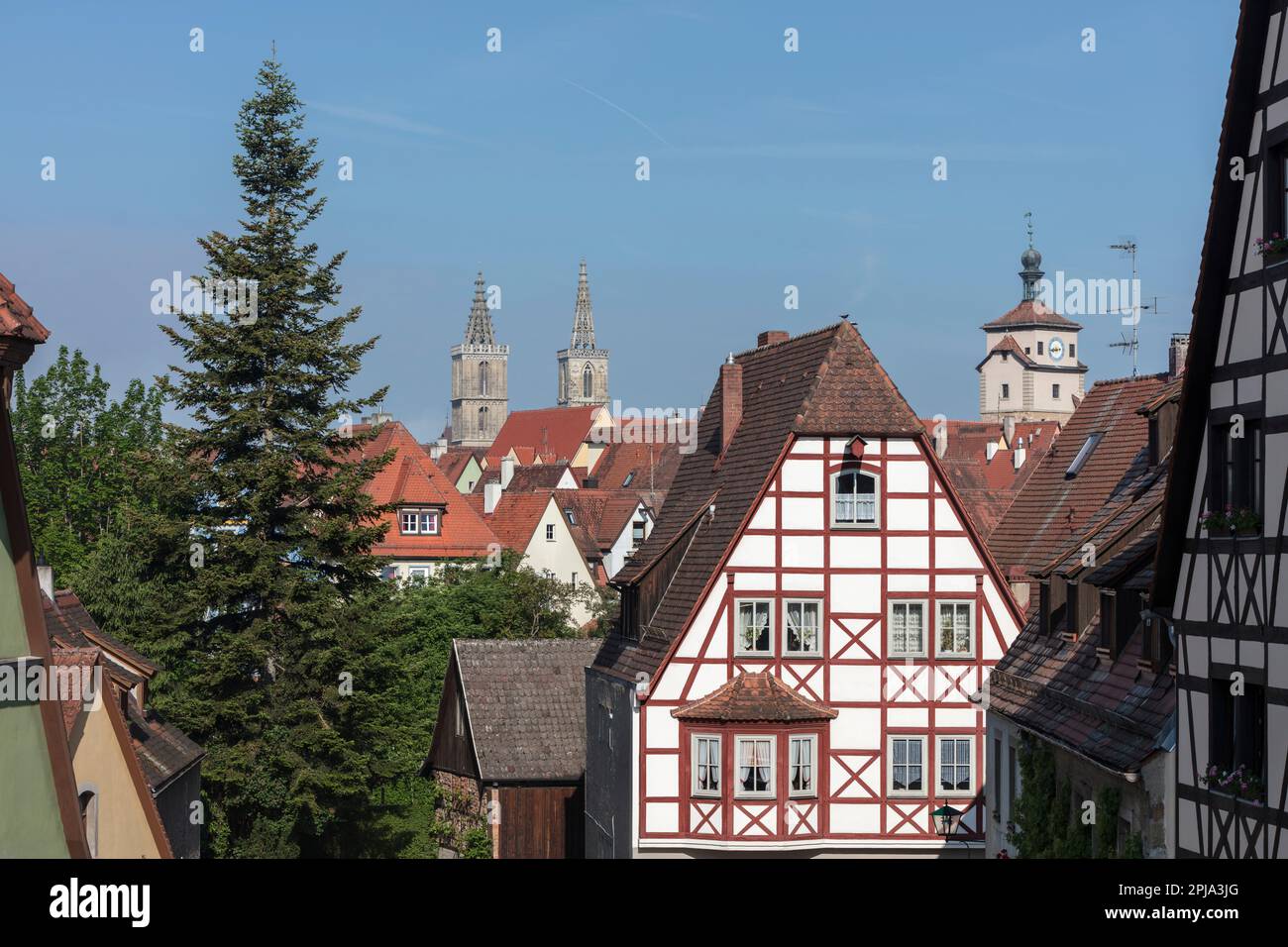 Twin towers of St Jakobs Church and White tower, Weisser Turm above medieval city's historic half timbered buildings Old Town, Altstadt, Rothenburg. Stock Photo