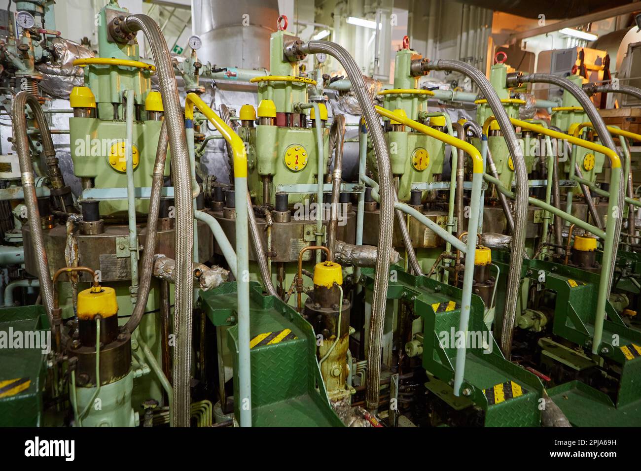 Ship's engine room. Vessel's ( Ship ) Engine Room Space / industrial stairs. Ship's Engine Heavy Machinery Space - Pipes, Valves, Engines Stock Photo