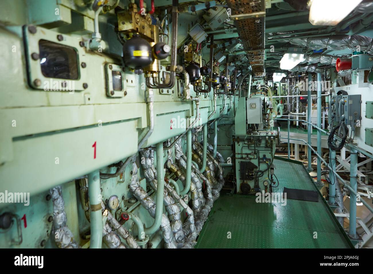 Ship's engine room. Vessel's ( Ship ) Engine Room Space / industrial stairs. Ship's Engine Heavy Machinery Space - Pipes, Valves, Engines Stock Photo