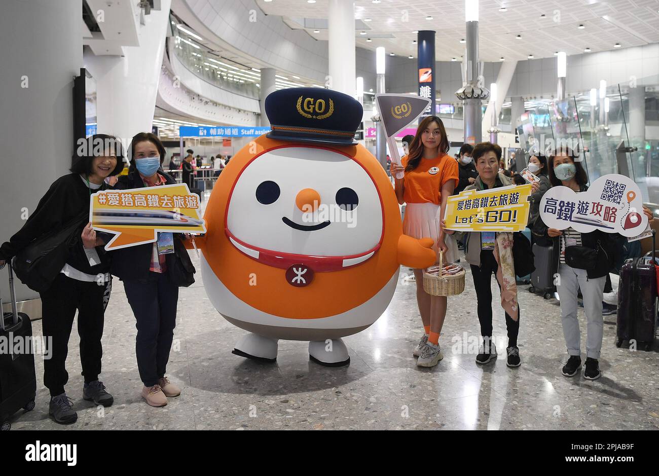 Hong Kong. 1st Apr, 2023. Passengers pose for a group photo at the West Kowloon Station in south China's Hong Kong, April 1, 2023. The long-haul services of the Express Rail Link (XRL) Hong Kong Section fully resumed on Saturday, connecting the financial hub with destinations outside the neighboring Guangdong province. TO GO WITH 'High-speed railway services between Hong Kong, mainland fully resume' Credit: Chen Duo/Xinhua/Alamy Live News Stock Photo