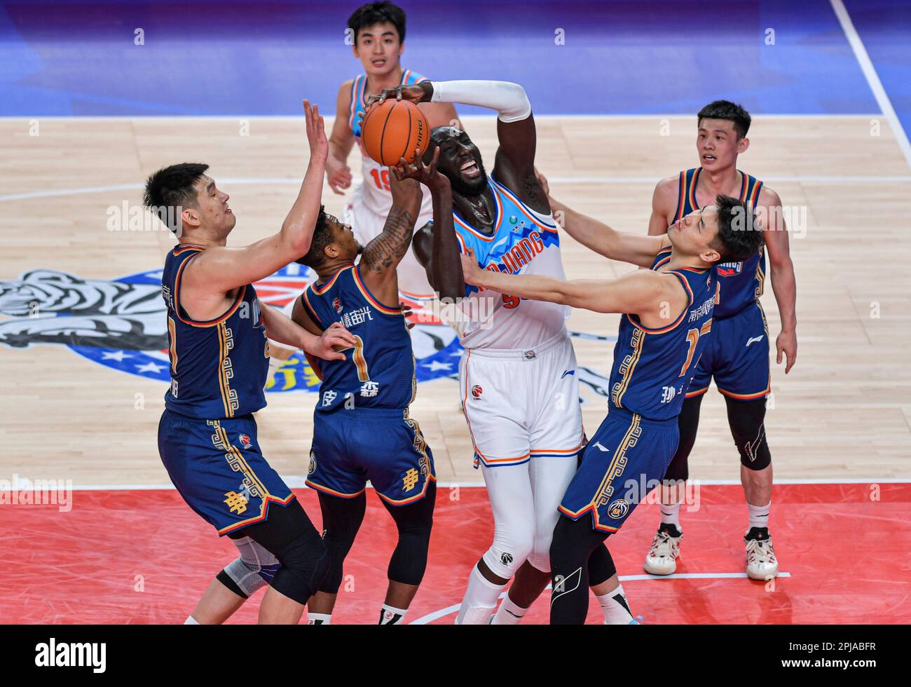 Urumqi, China's Xinjiang Uygur Autonomous Region. 1st Apr, 2023. Tacko Fall (C) of Xinjiang