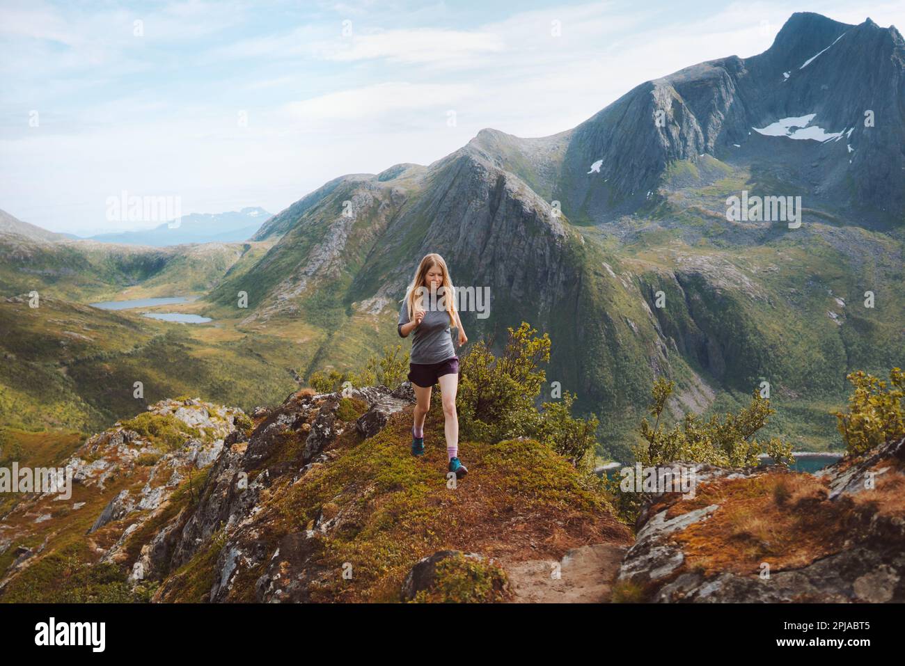 Woman trail running in mountains training outdoor travel healthy lifestyle adventure hiking vacations motivation endurance concept Norway nature Senja Stock Photo