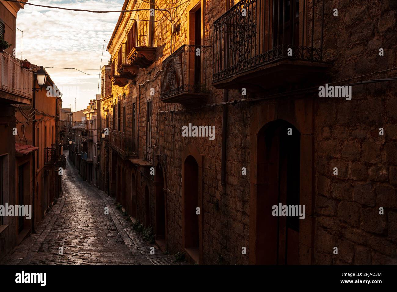Street with old houses of Aidone at sunset in the Enna province, Sicily in Italy Stock Photo