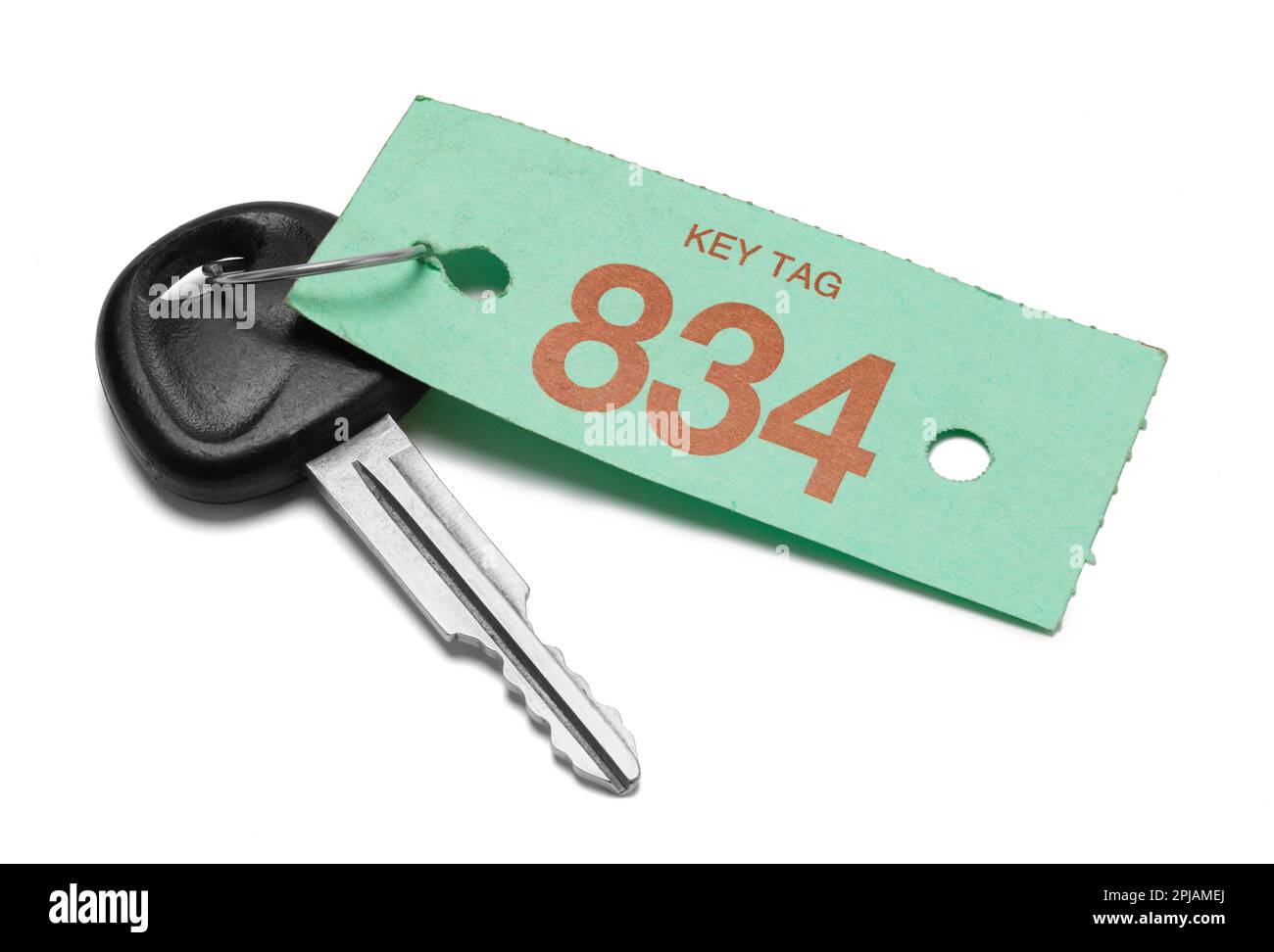 Car key With Green Service Tag Cut Out on White. Stock Photo