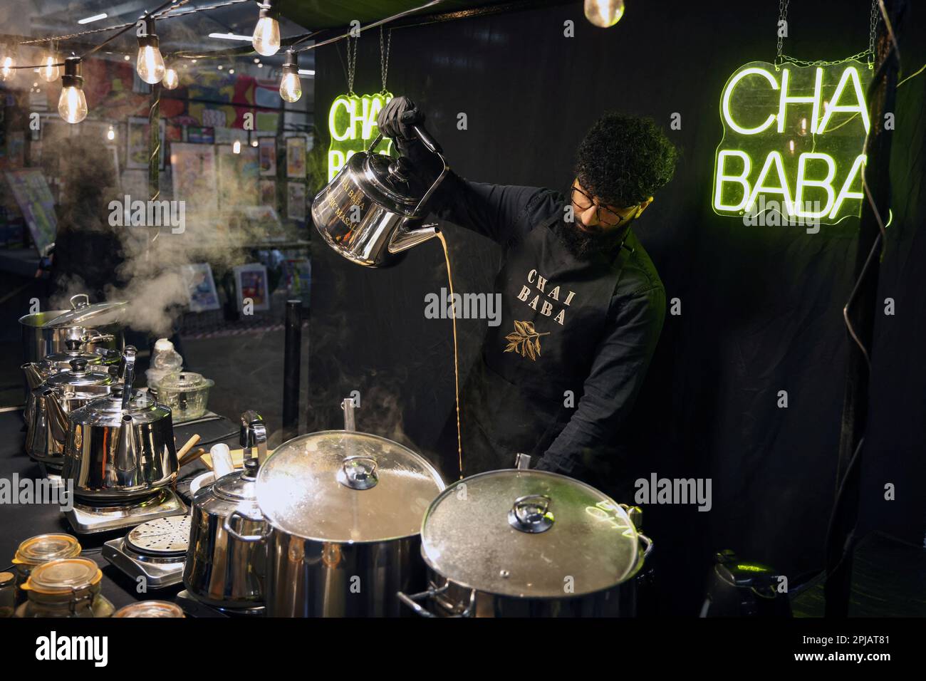 Mohsan Qureshi, who runs Chai Baba tea stall in Brick Lane market, pours tea imported from India