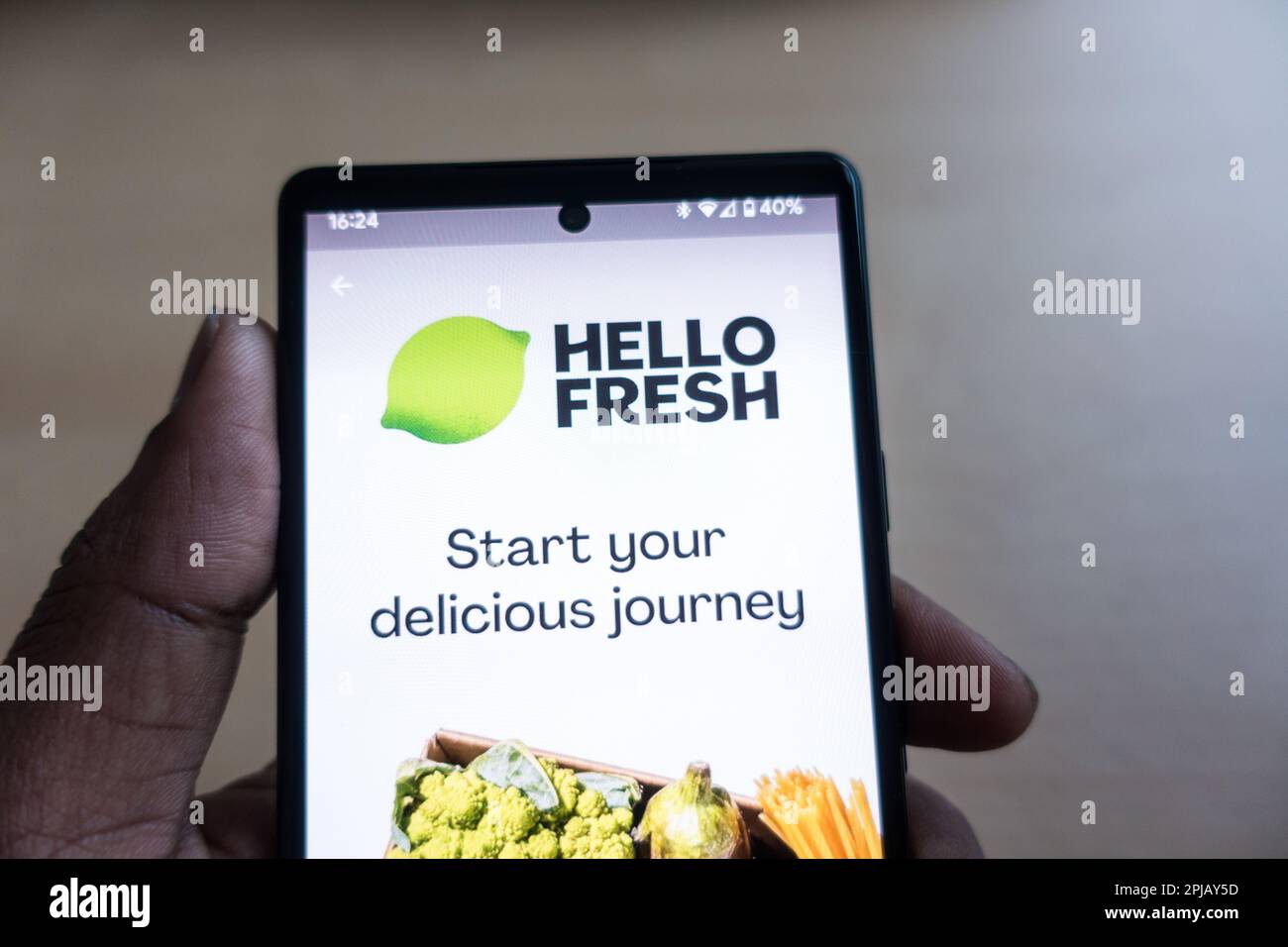 Adult male hand holding smartphone with Hello Fresh app Stock Photo