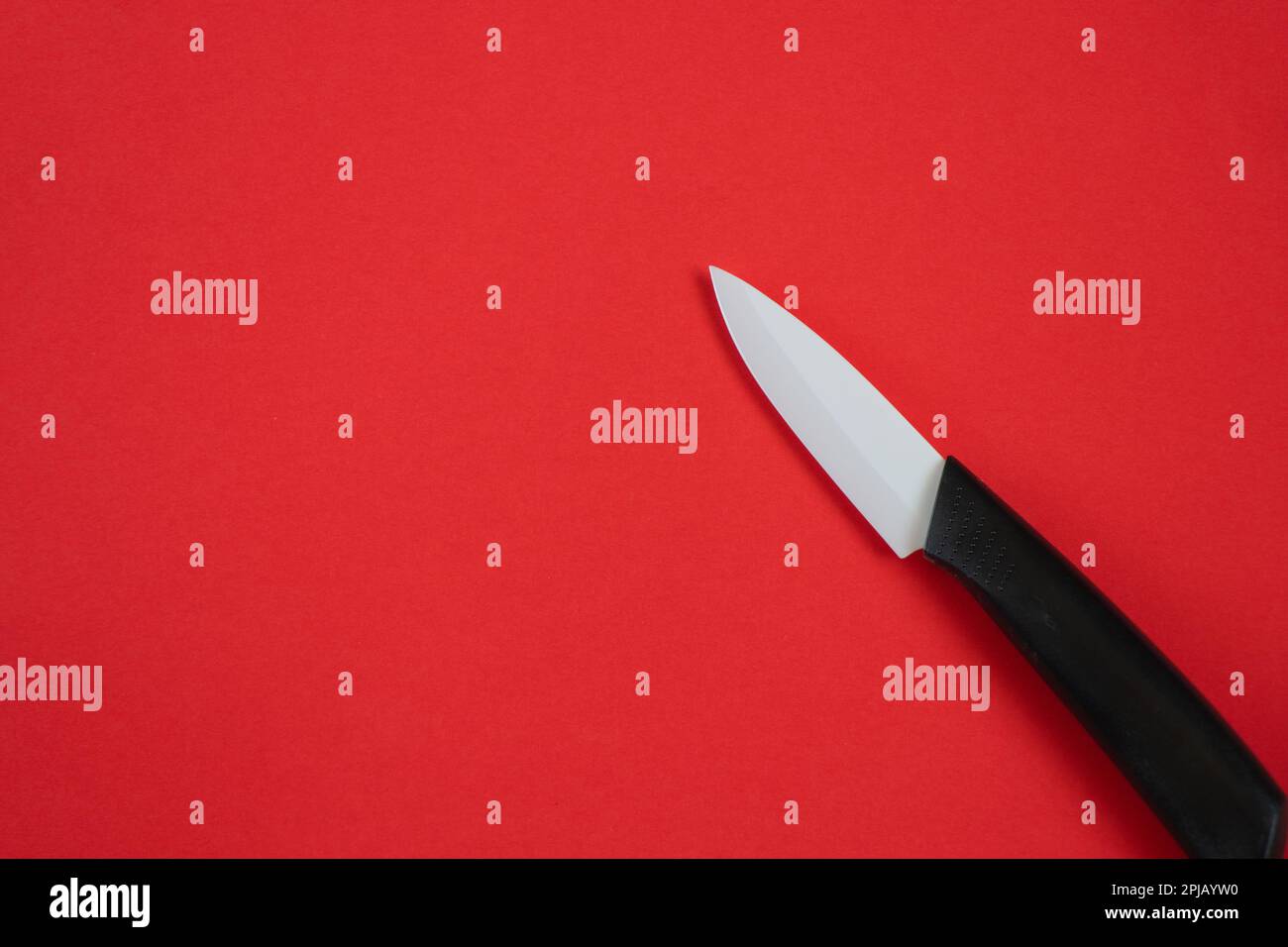 ceramic knife on a red background in isolation Stock Photo Alamy