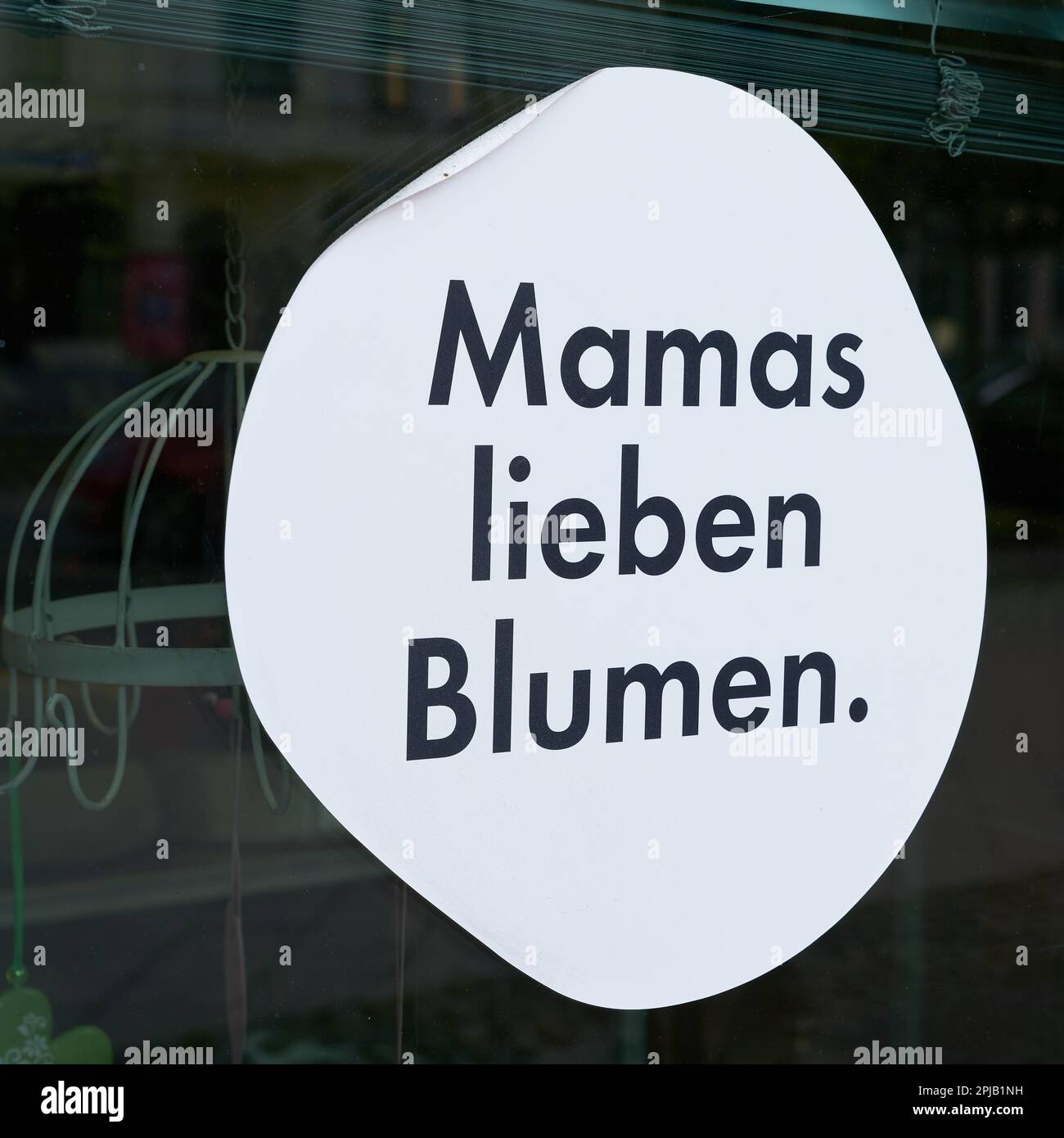 Sticker on the window of a flower store with the German inscription
