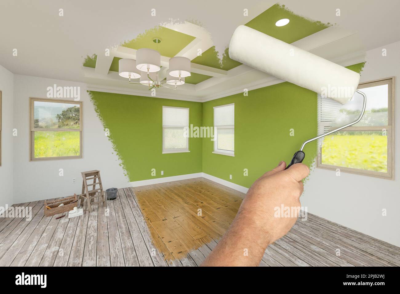 Before and After of Man Using A Paint Roller to Reveal Newly Remodeled Room with Fresh Green Paint, Coffered Ceiling and New Floors. Stock Photo