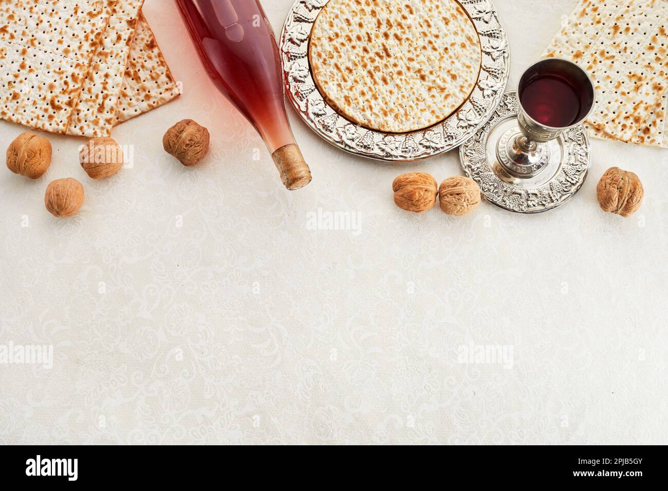 Passover celebration concept. Matzah, red kosher and walnut Stock Photo