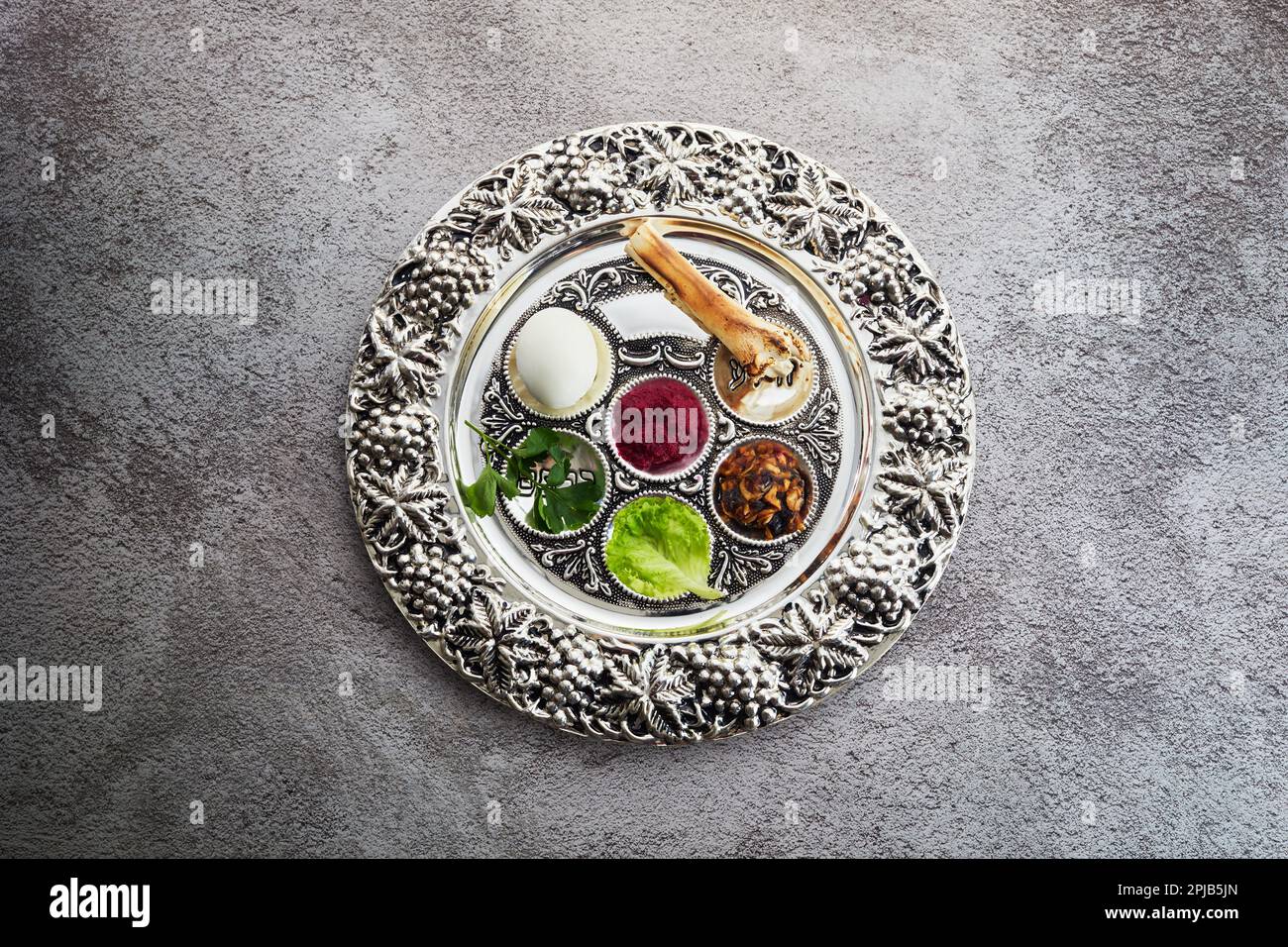 Passover Seder plate with traditional food on grunge background Stock ...