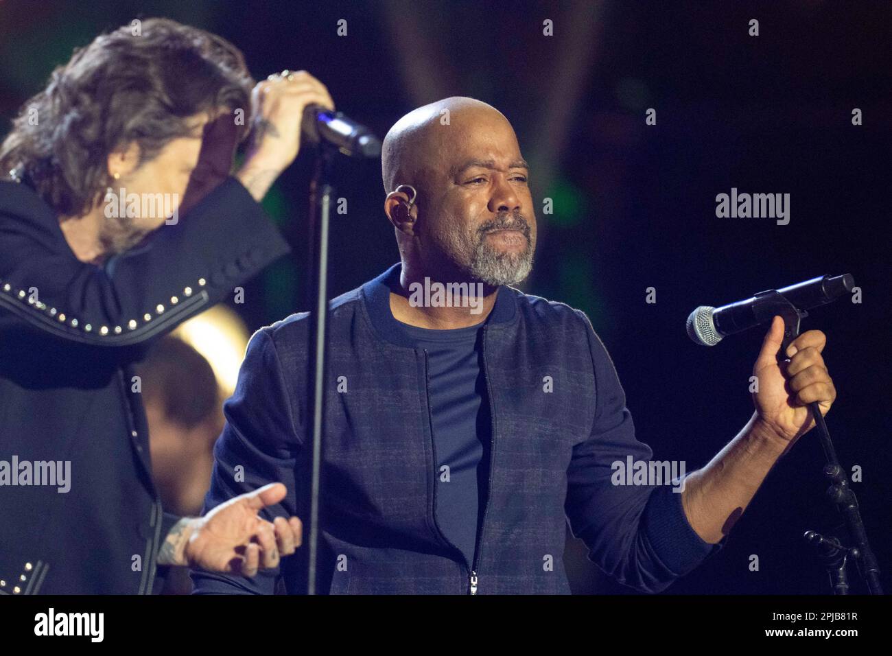 Austin Texas USA, March 31 2023: Chris Robinson of the Black Crowes and country star Darius Rucker perform together during a taping of Country Music Television's long-running Crossroads show at an outdoor stage in downtown. The show brings together a country artist with artists from another musical genre. ©Bob Daemmrich Stock Photo