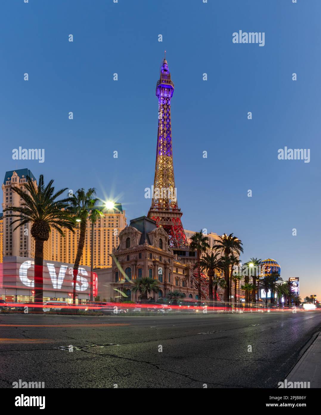 A picture of the Paris Las Vegas at sunset, with the Eiffel Tower decorated with the colors of the French flag. Stock Photo