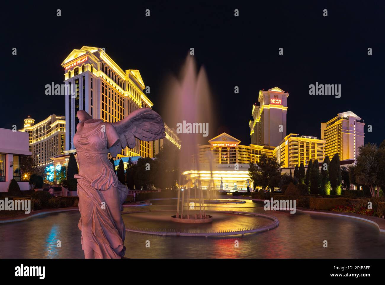 A picture of the Caesars Palace at night as seen from its fountains, with the Nike of Samothrace statue on the left side. Stock Photo