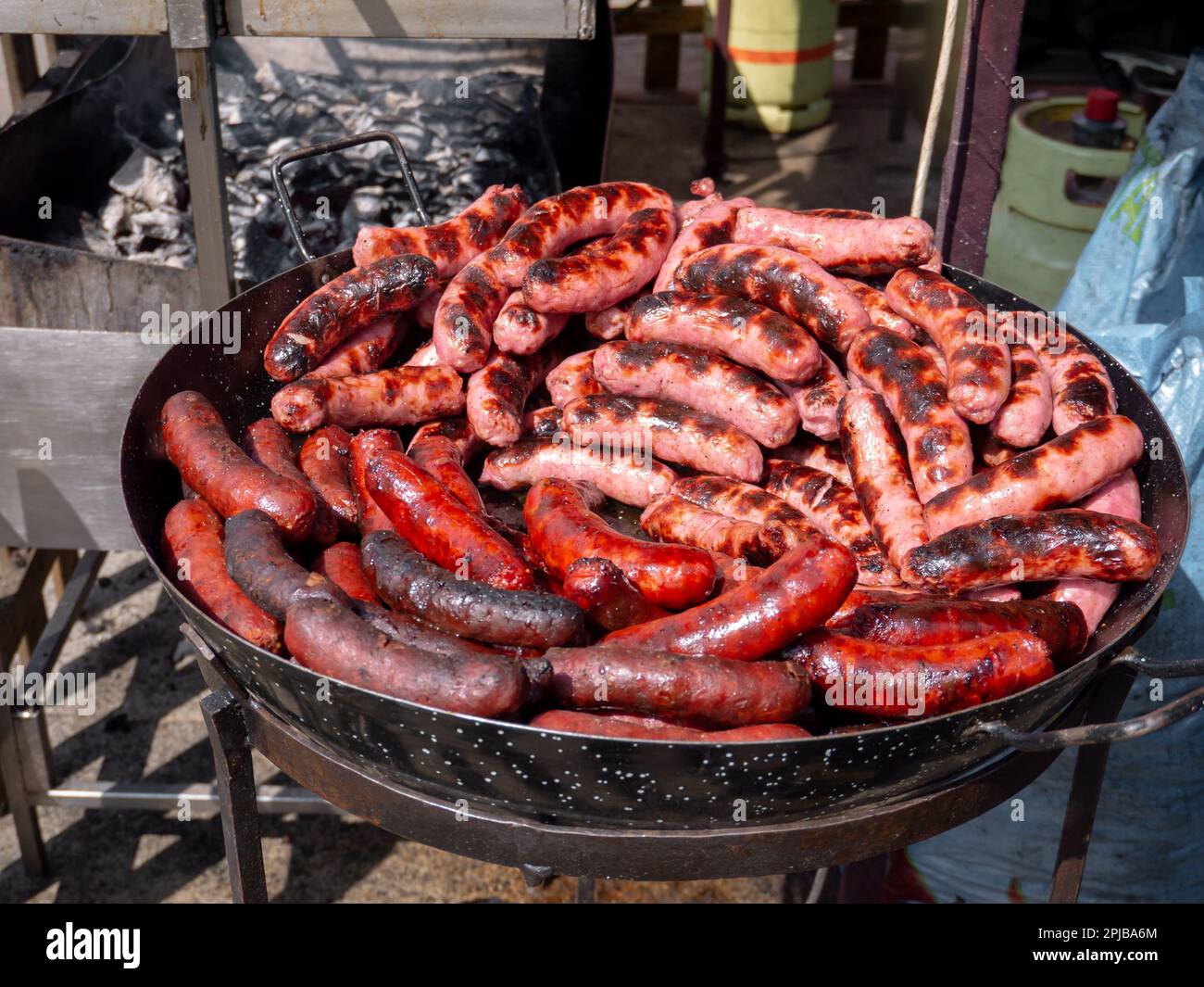 Spanish traditional fresh red and white sausages in the frying pan at the fair Stock Photo Alamy