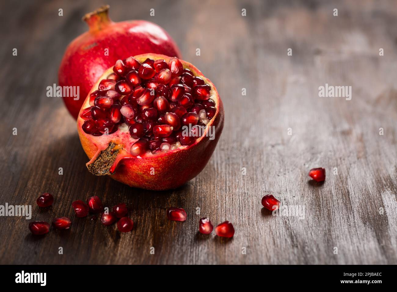 Pomegranate fruit on wooden vintage background Stock Photo