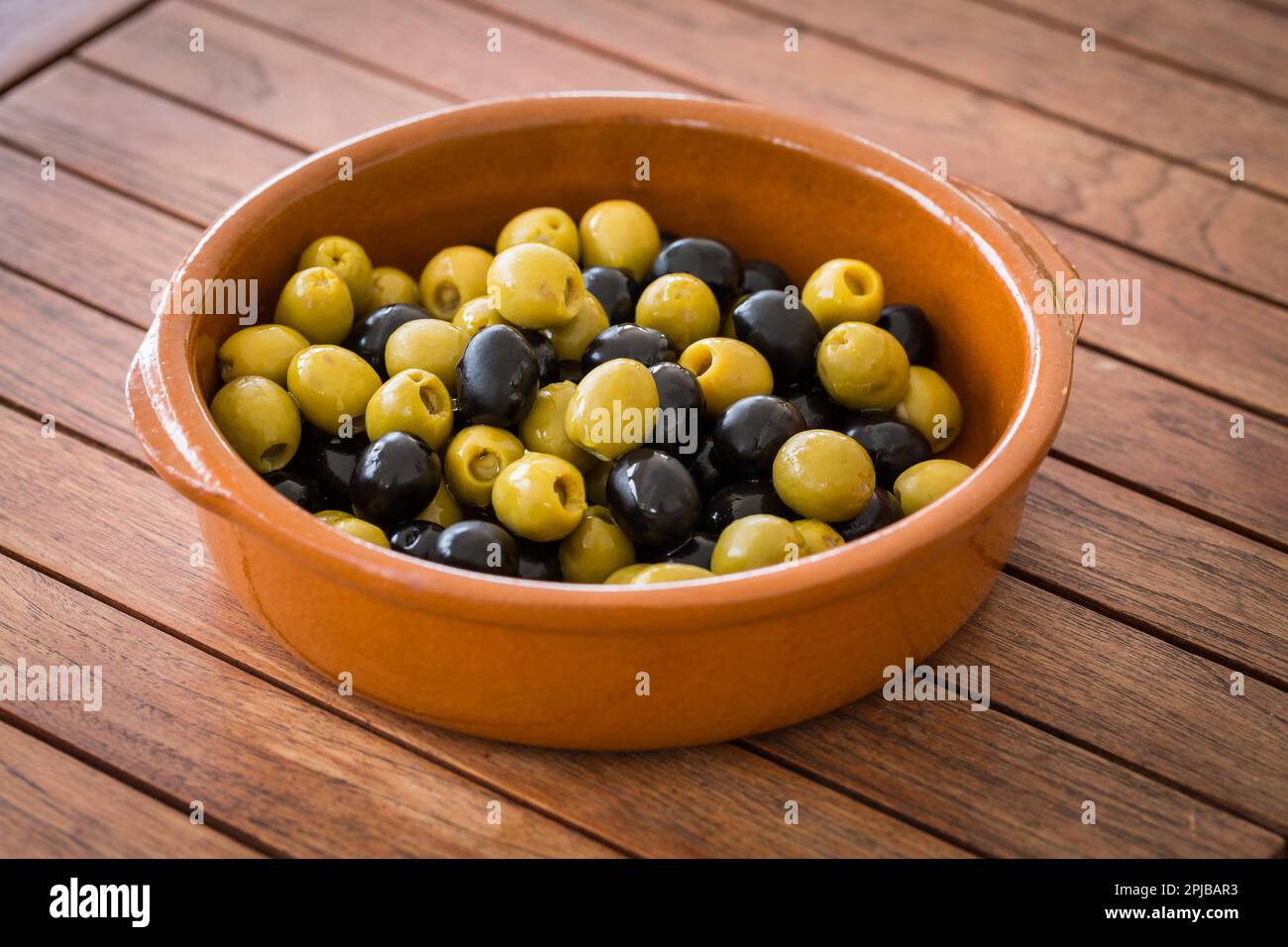 Spanish black and green olives in the bowl Stock Photo Alamy