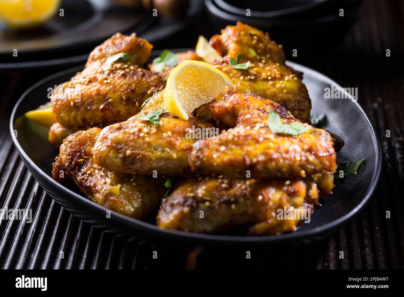 Spicy chicken wings with garlic, sesame and lemon marinade in Asia
