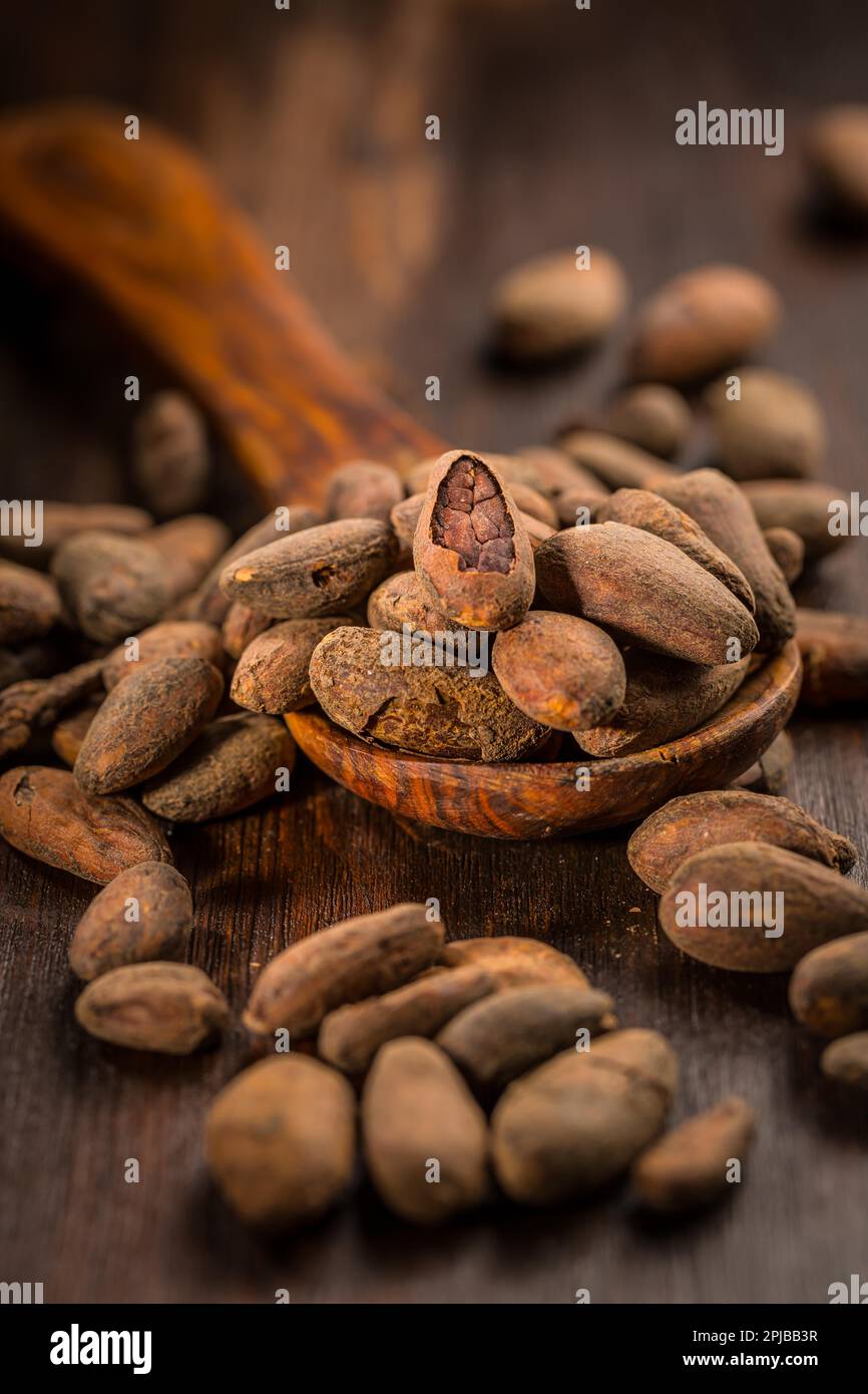 Cocoa beans on wooden background Stock Photo