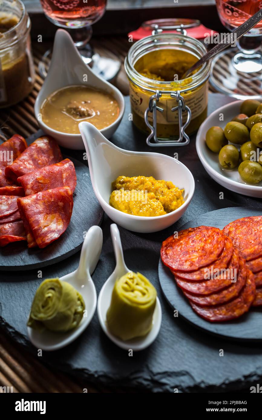 Assortment of tapas and antipasti on black background. Charcuterie