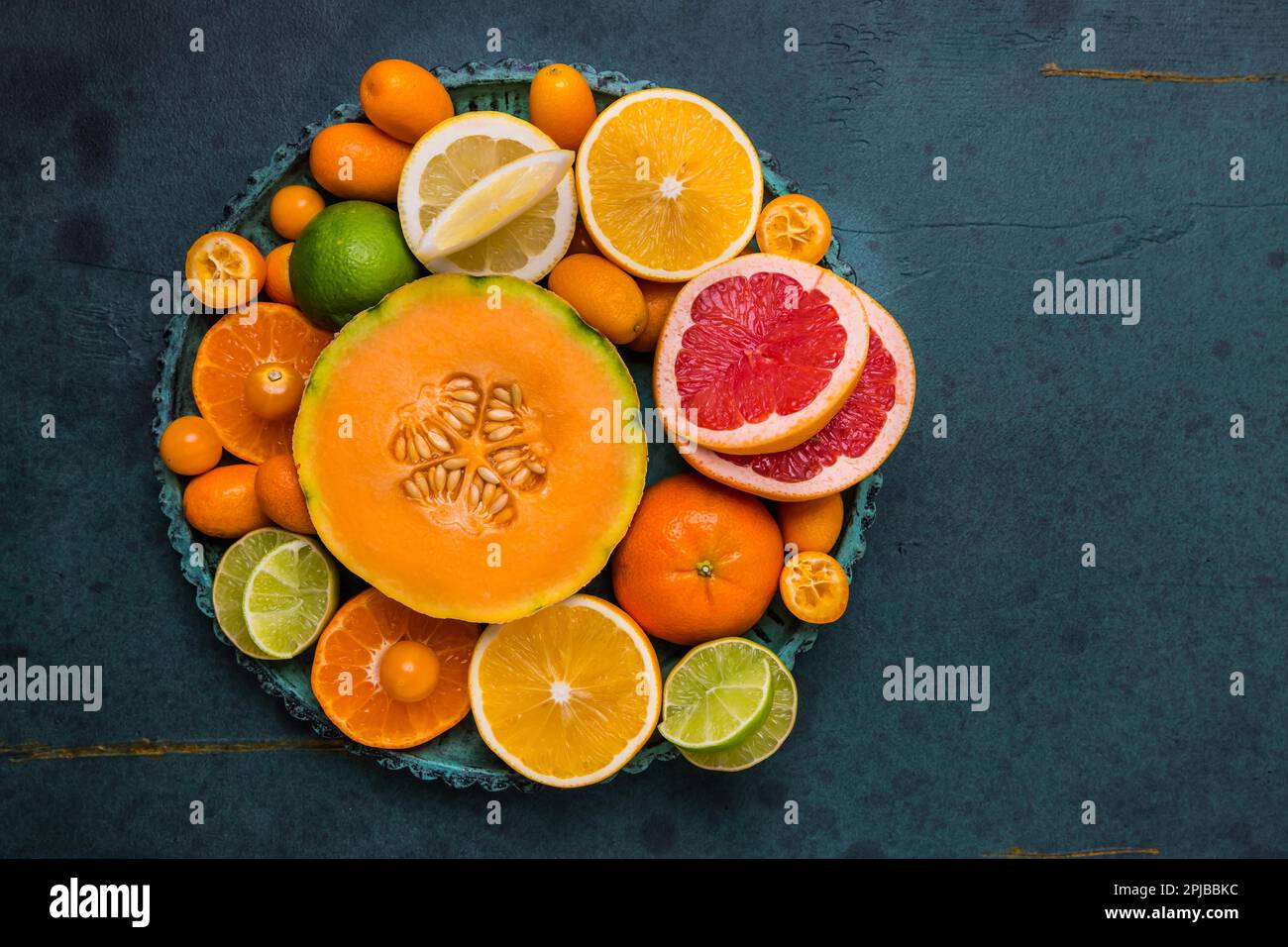 Flat lay layout of fruit citrus and other summer fruits on green background. Healthy eating concept Stock Photo