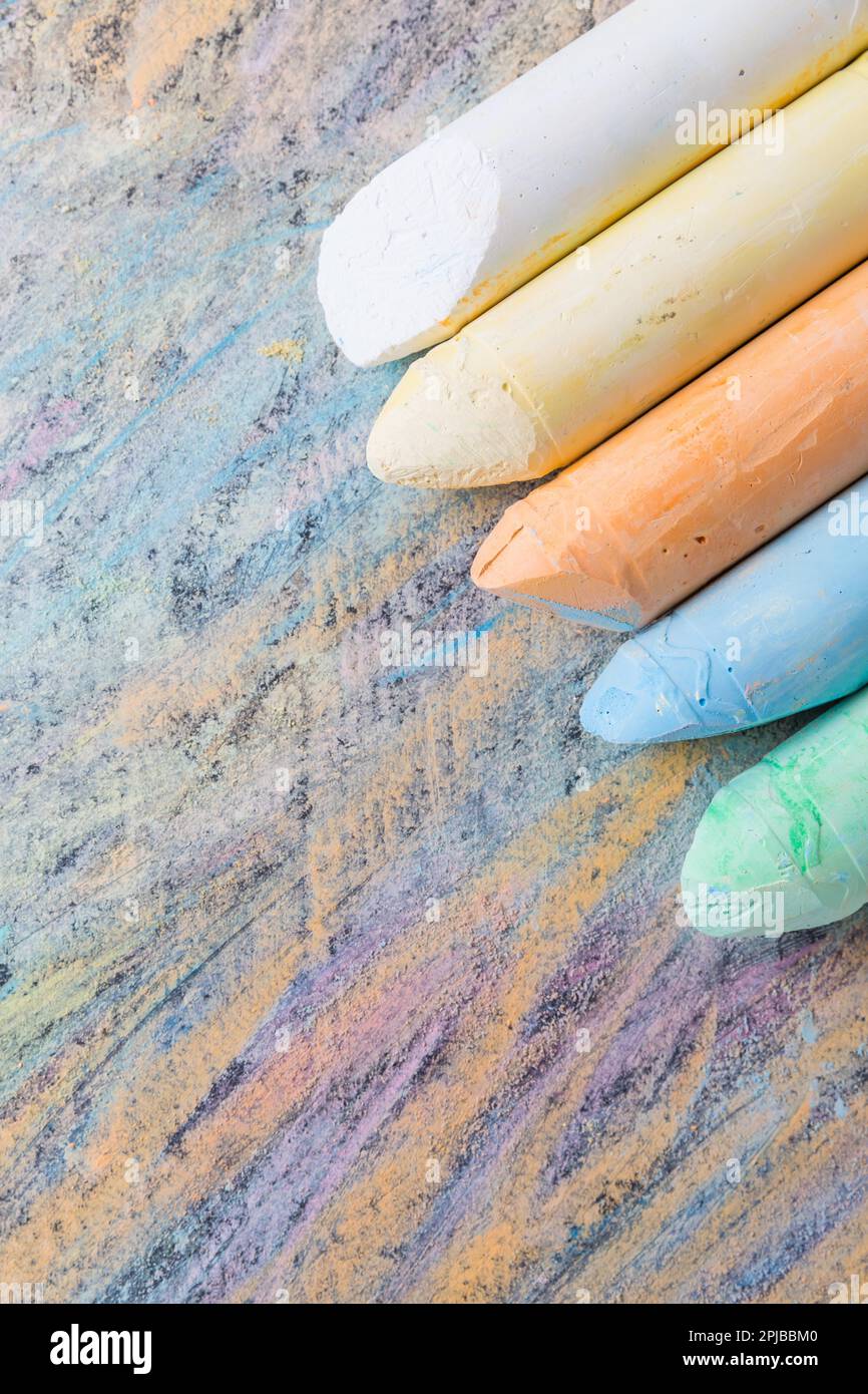Chalks with colorful painted background. Back to school and art concept with copy space Stock Photo