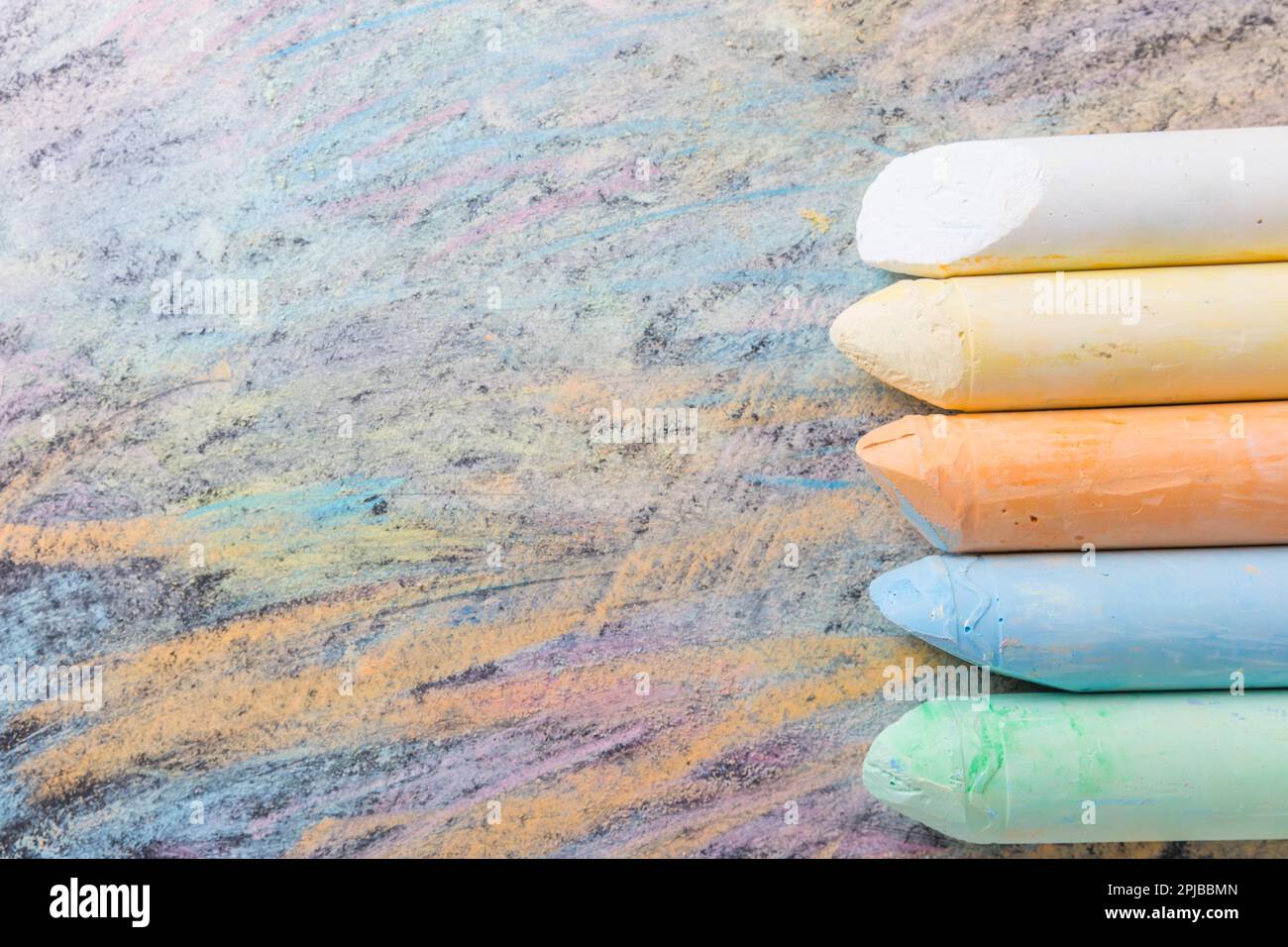 Chalks with colorful painted background. Back to school and art concept with copy space Stock Photo