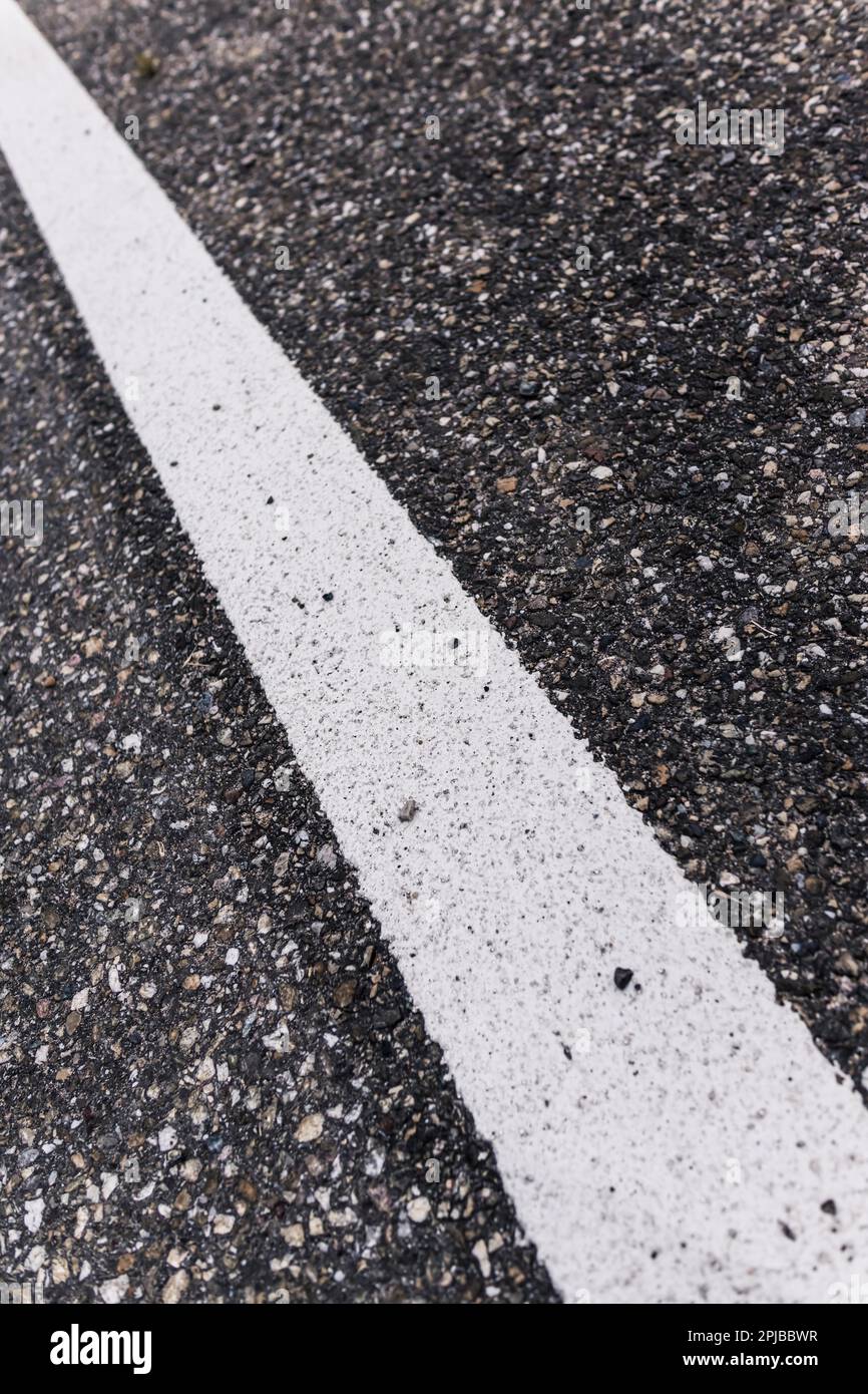 Old asphalt road with separation line. Selective focus Stock Photo