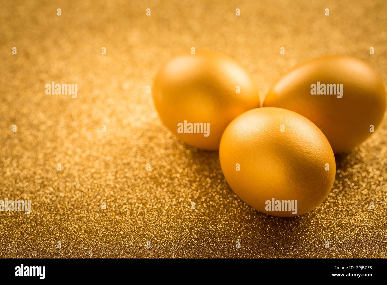 Golden eggs on golden background for Easter Stock Photo