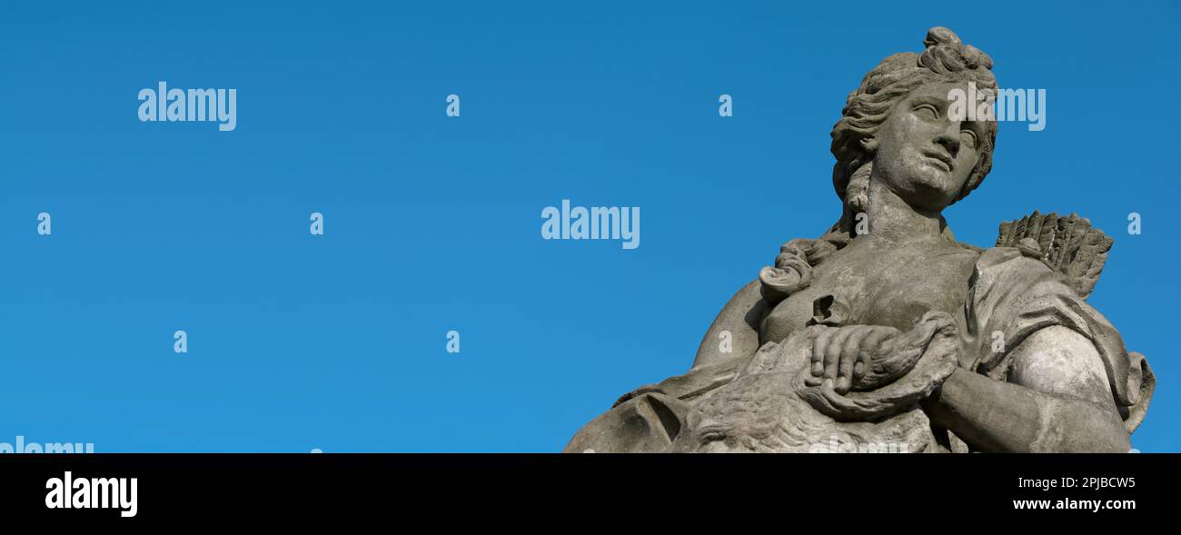 Baroque statue of a woman with blue sky in panoramic format Stock Photo