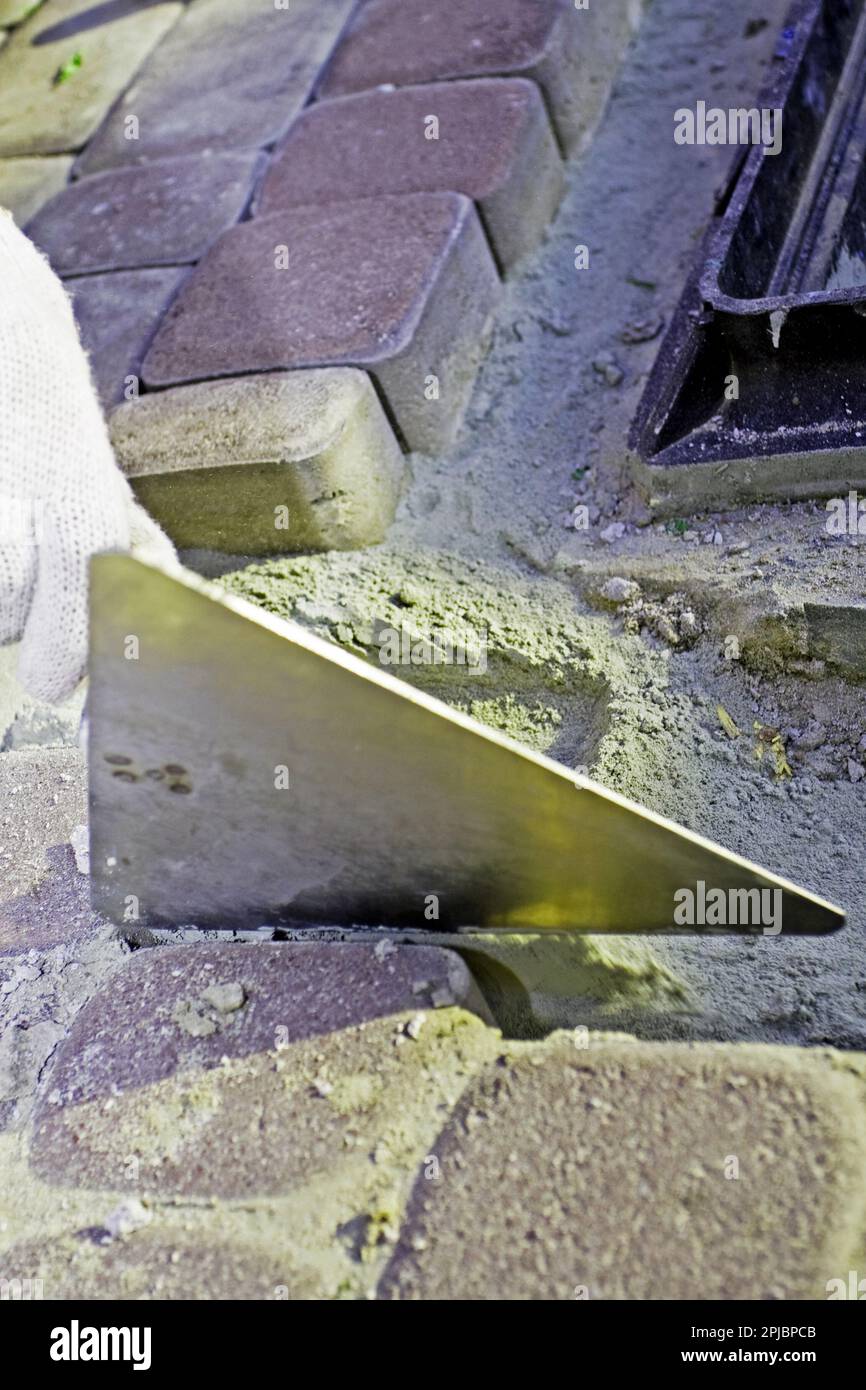 Construction worker fixing the pavestone Stock Photo