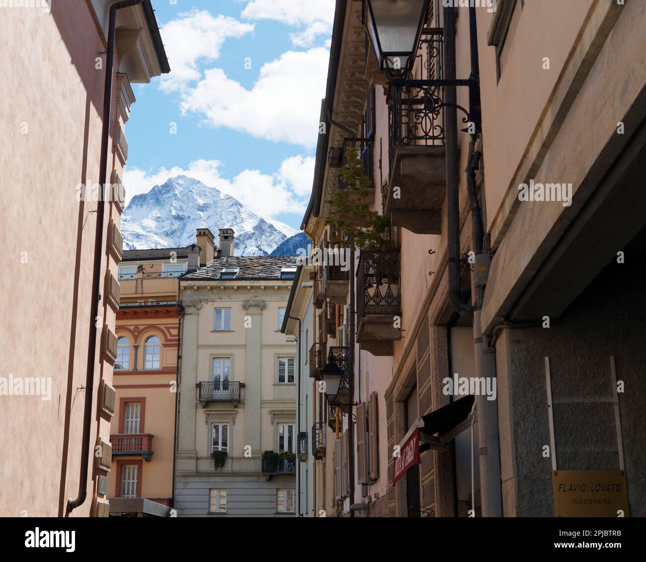Pastel coloured properties with balconies in the city of Aosta with the