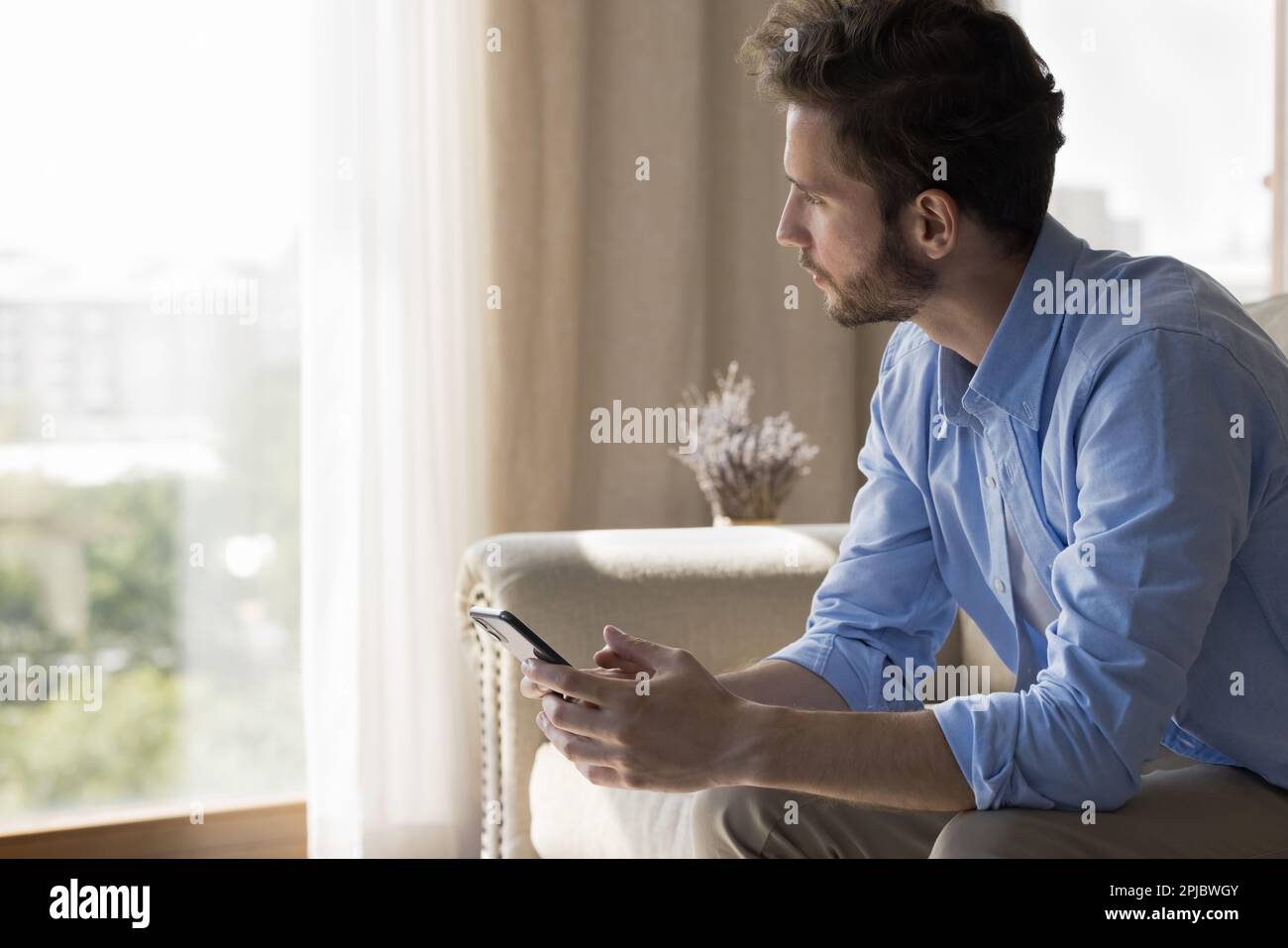 Serious freelance business man using application on smartphone Stock Photo