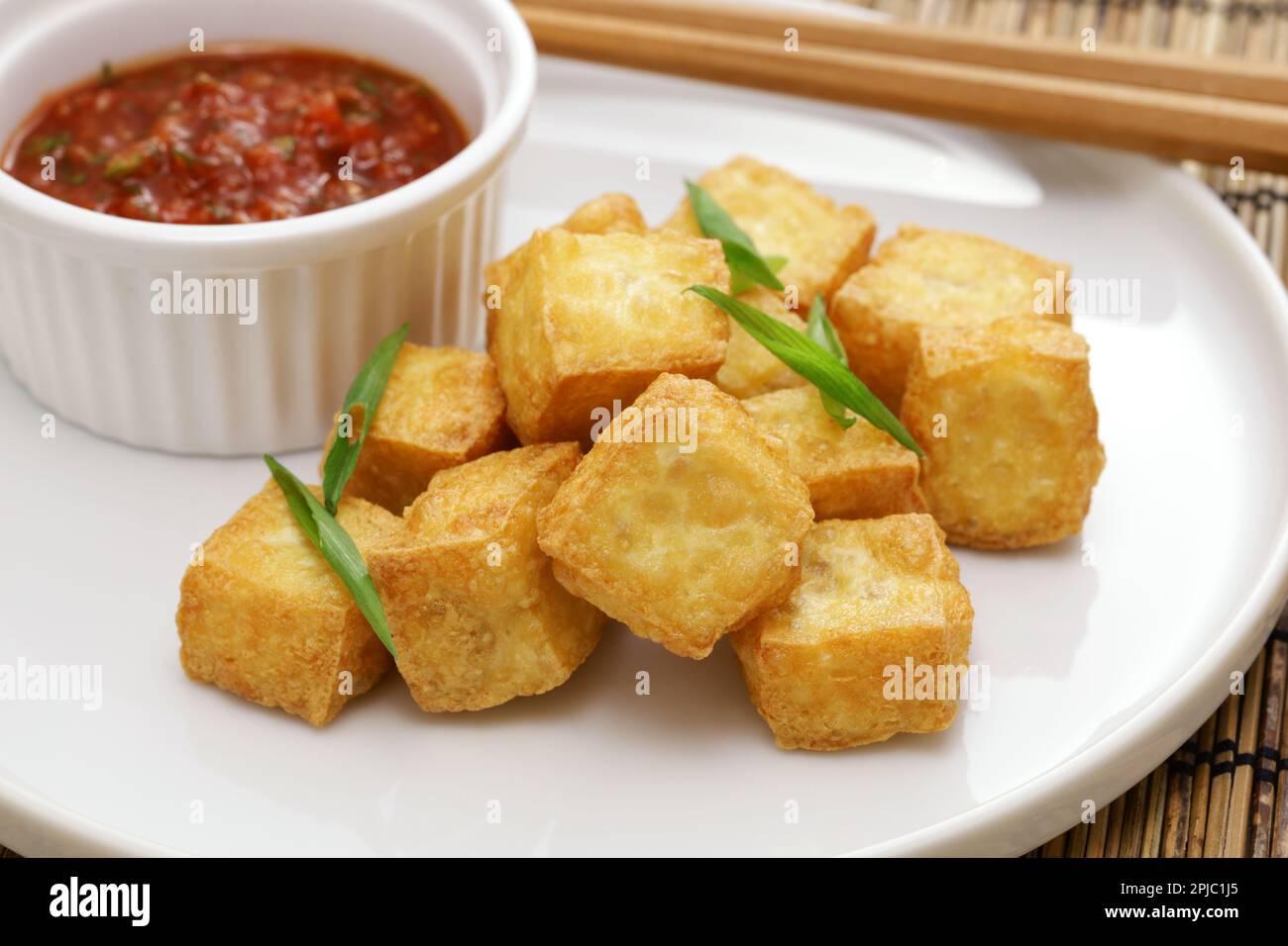 crispy cubed tofu puffs with chili sauce Stock Photo