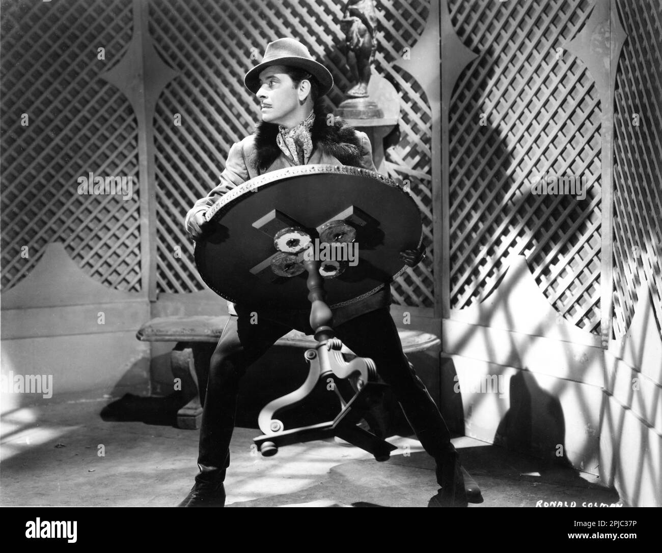 RONALD COLMAN fighting with furniture in THE PRISONER OF ZENDA 1937 director JOHN CROMWELL novel Anthony Hope screenplay John L. Balderston music Alfred Newman costumes Ernest Dryden art direction Lyle R. Wheeler producer David O. Selznick Selznick International Pictures / United Artists Stock Photo