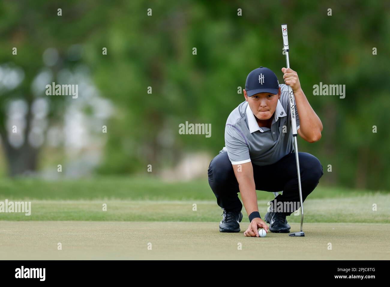 Danny Lee of Iron Heads GC reads his putt on the second green during