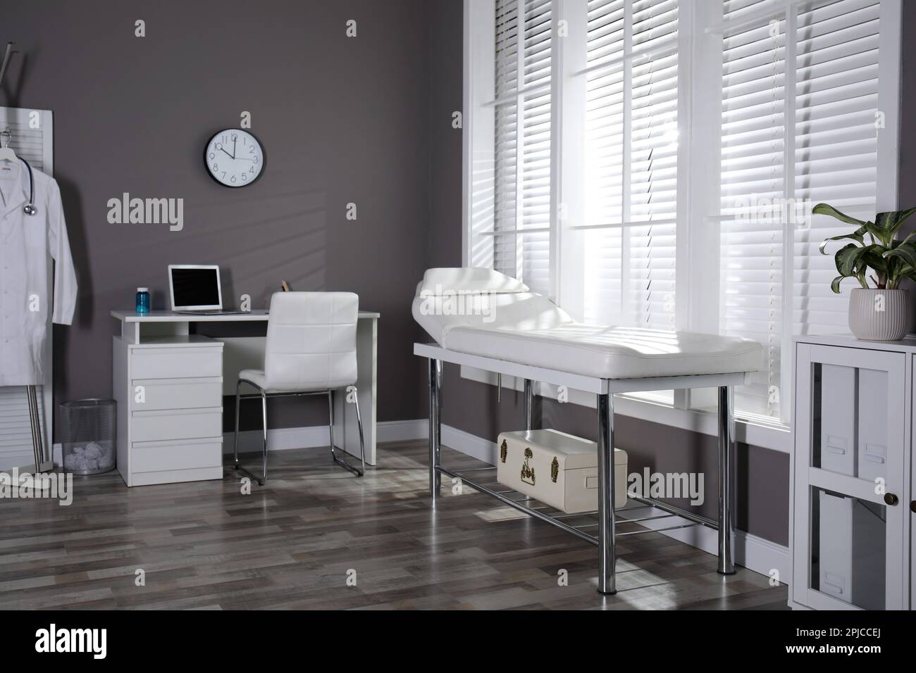 Modern medical office interior with doctor's workplace and examination ...