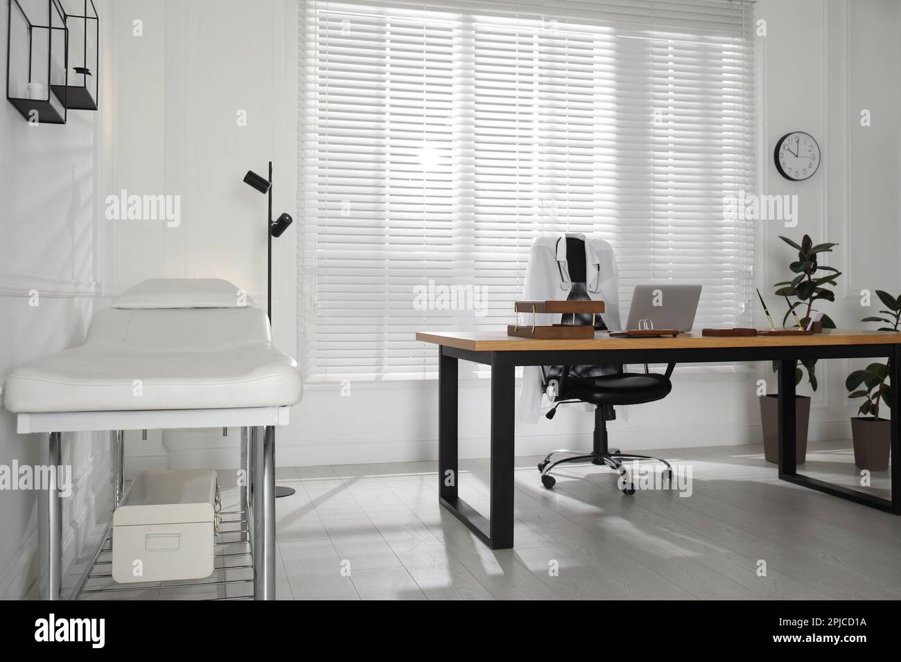 Modern medical office interior with doctor's workplace and examination ...