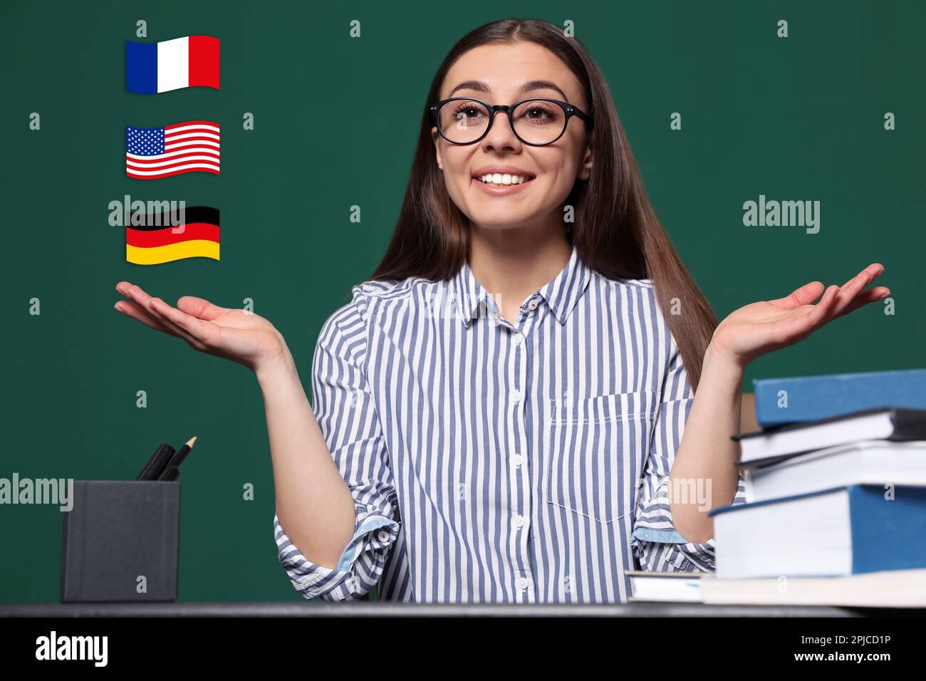 Portrait of foreign languages teacher at table and different flags