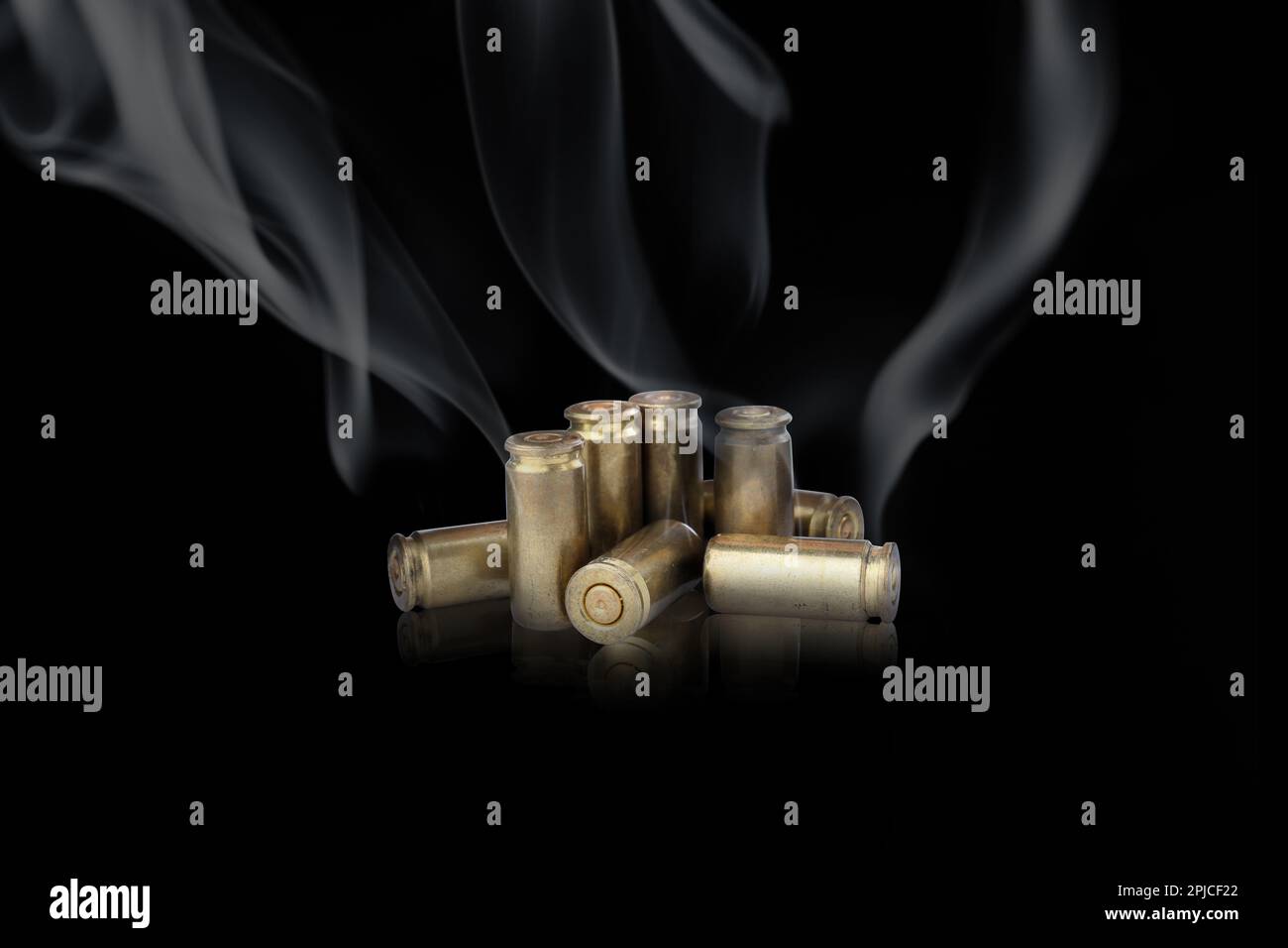 Cartridge cases with smoke on black background Stock Photo Alamy