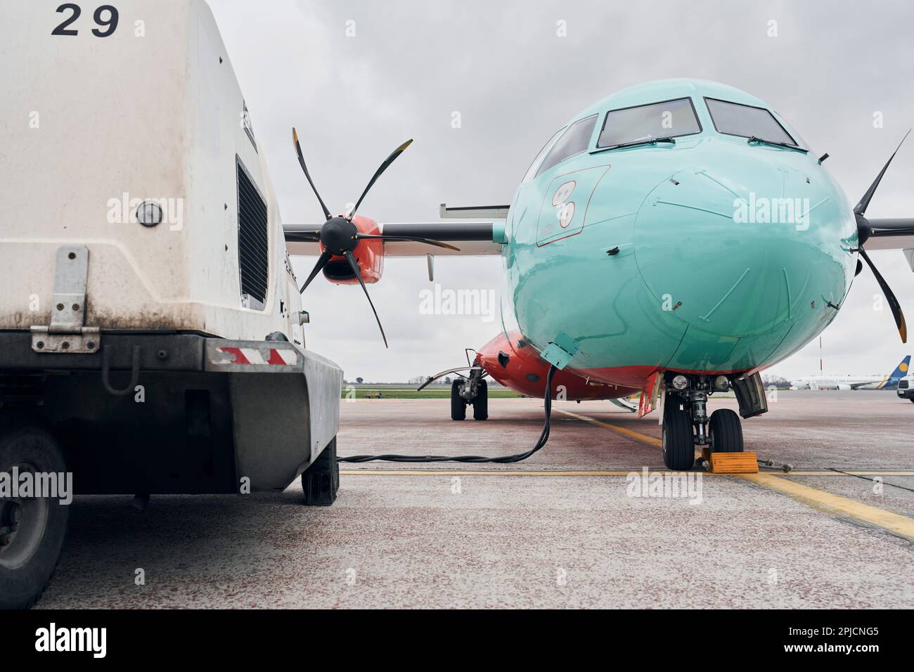 Turboprop aircraft parked on the runway at daytime Stock Photo - Alamy