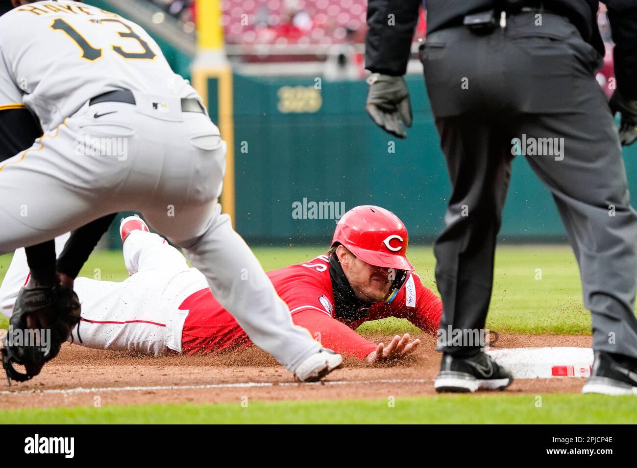Cincinnati Reds' Wil Myers slides safely into third base past