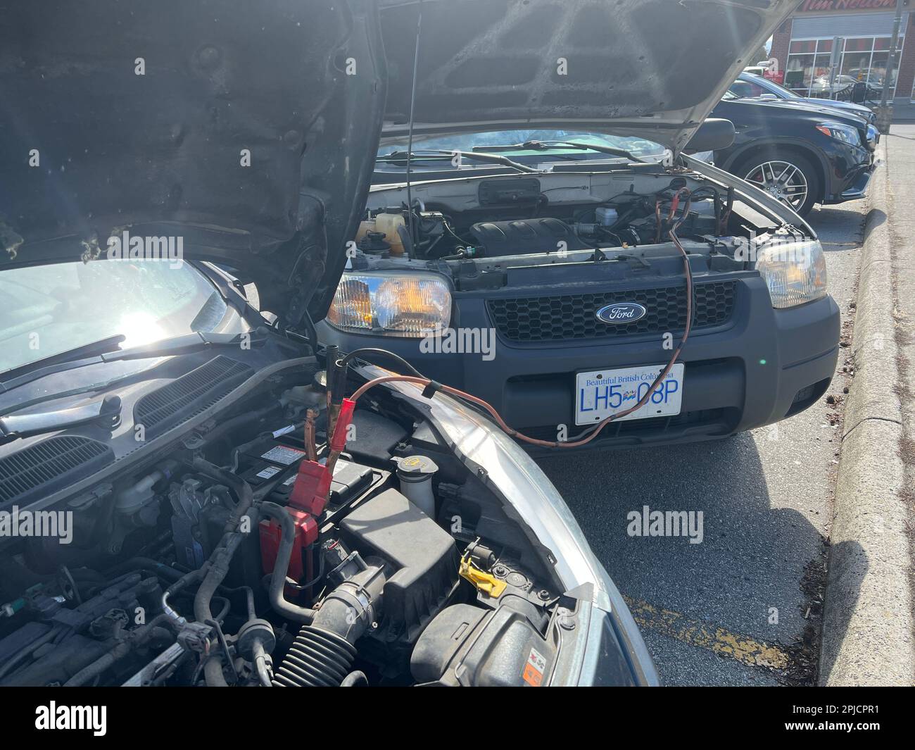 Charging a car battery in winter. Help on the road. Closeup