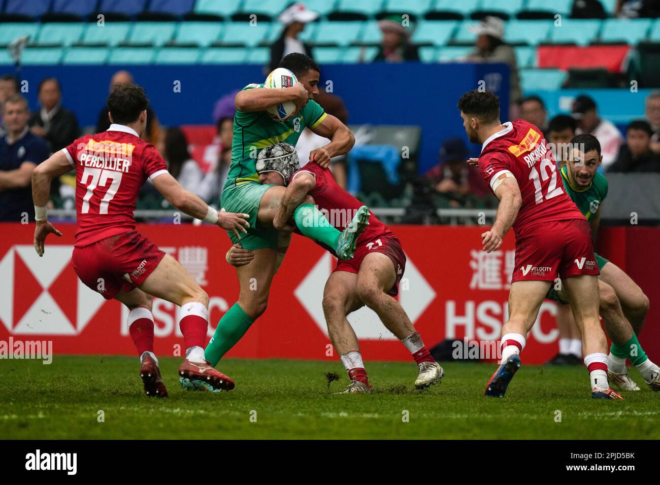 Ireland's Jordan Conroy, center left, is tackled by Canada's Max Stewart  during the 9th place quarterfinal match of the Hong Kong Sevens rugby  tournament in Hong Kong, Sunday, April 2, 2023. (AP