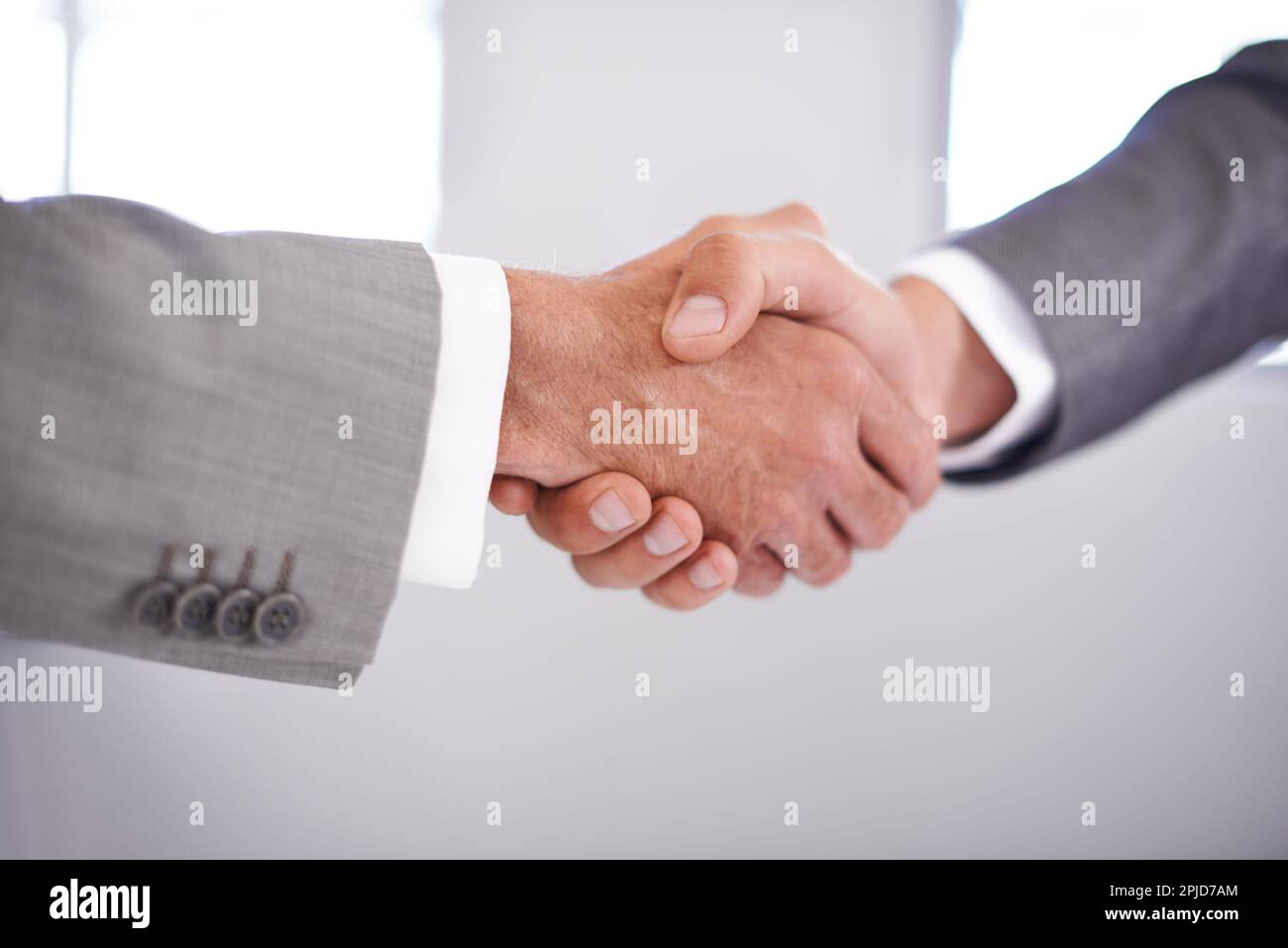 Theyre in agreement. Cropped closeup shot of two businessmen shaking hands. Stock Photo